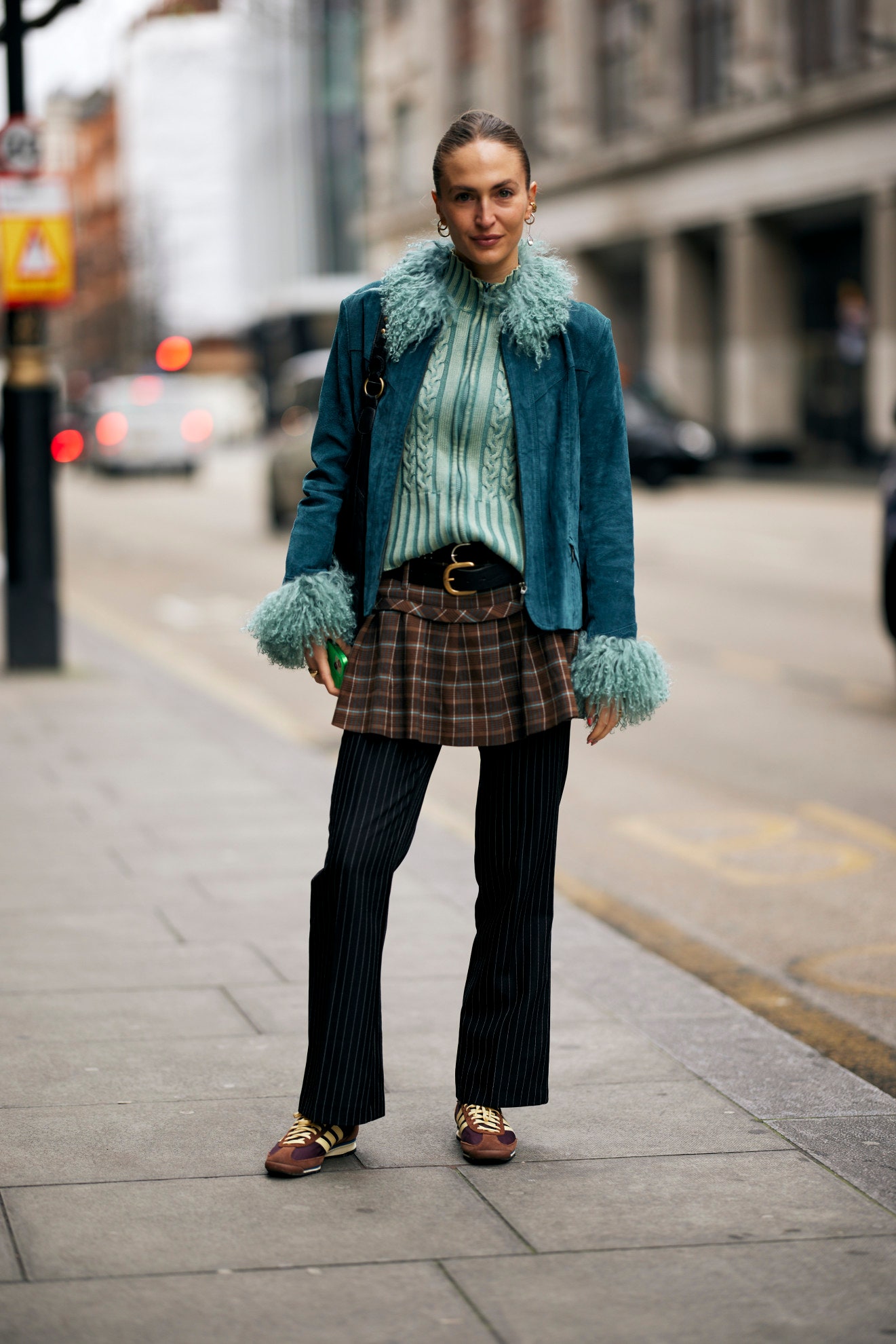 Image may contain Clothing Pants Person Coat Standing Adult and Skirt