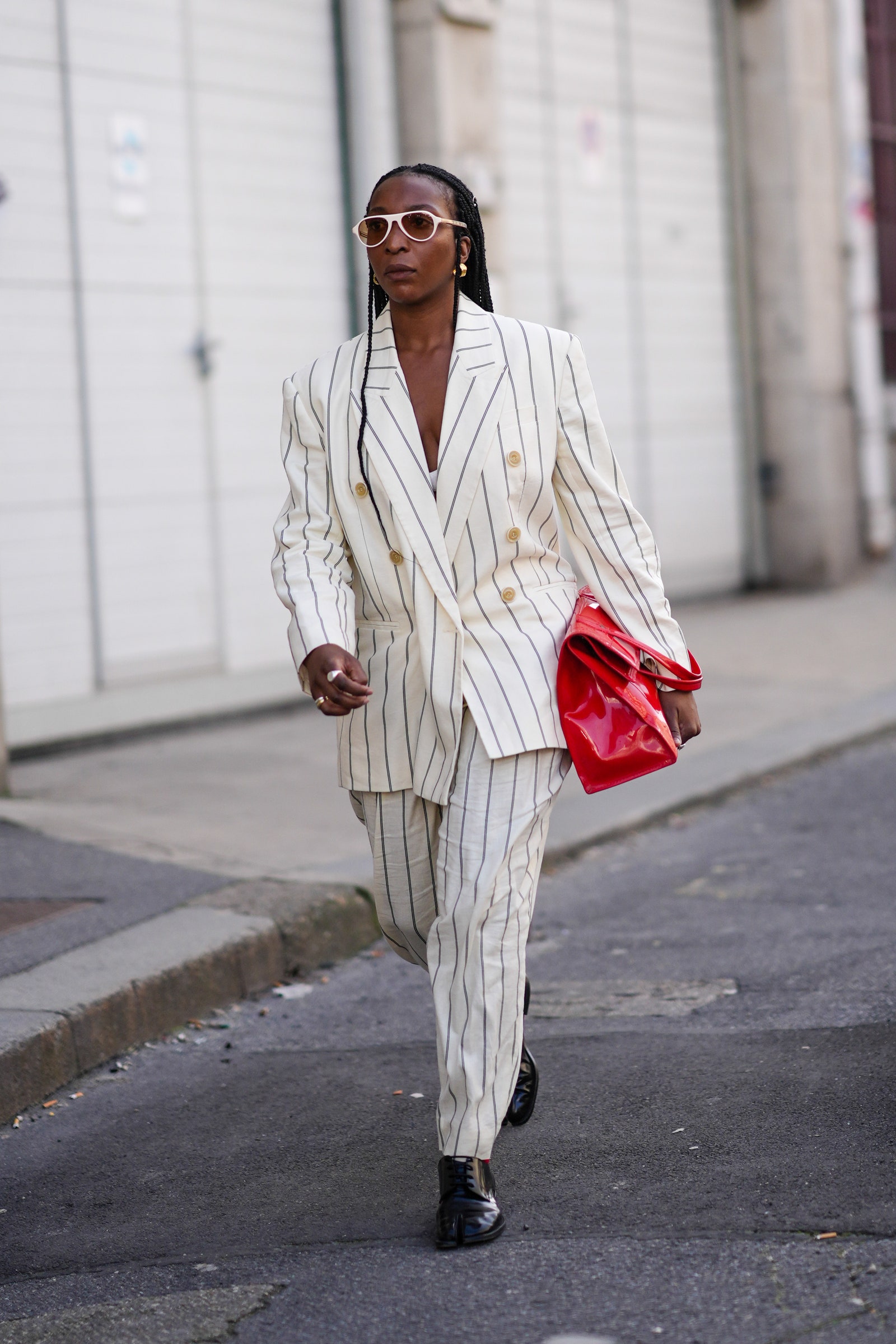 Image may contain Clothing Formal Wear Suit Pedestrian Person Standing Coat Adult Blazer Jacket and Accessories