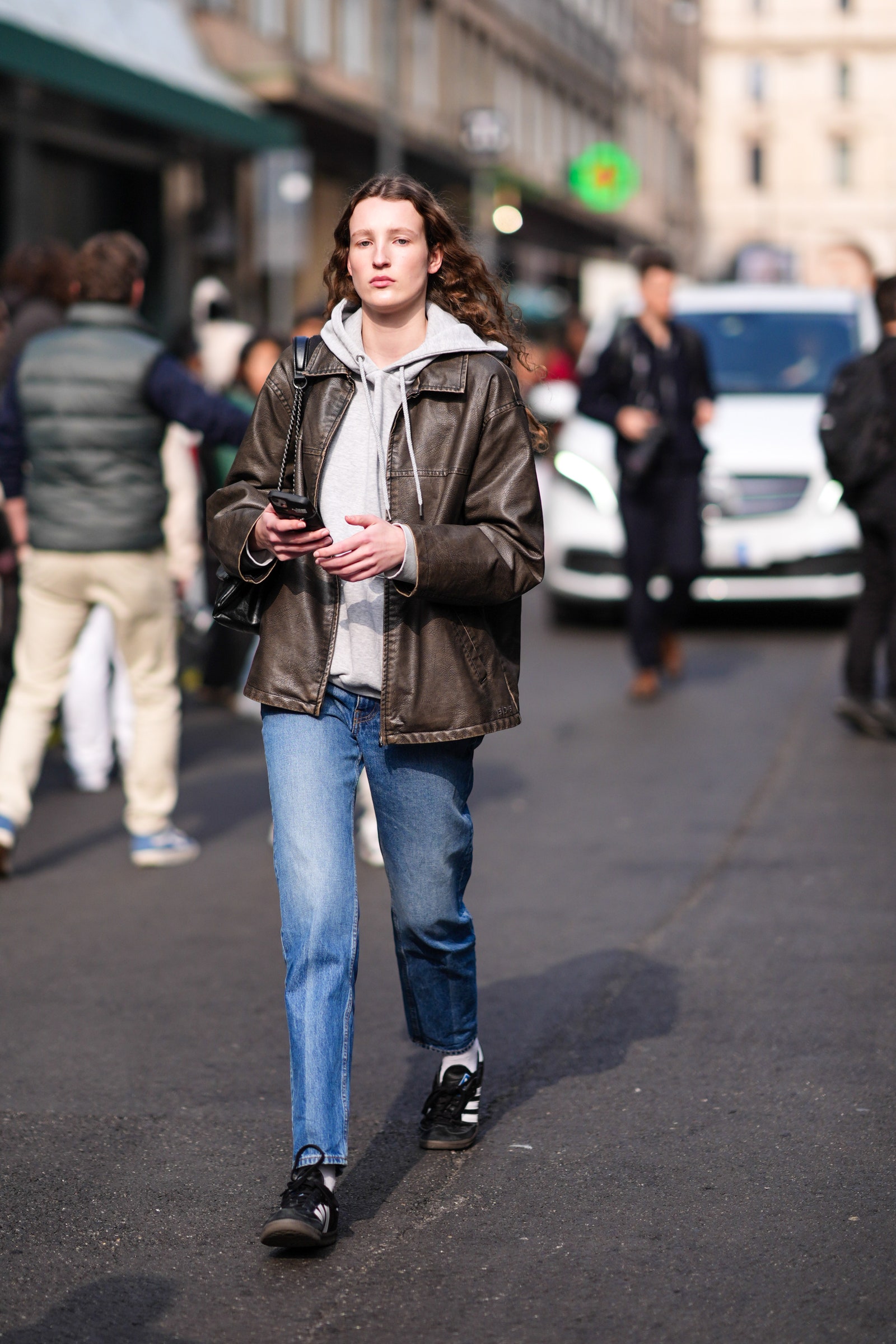 Image may contain Clothing Coat Jacket Pants Footwear Shoe Jeans Pedestrian Person Adult Car and Transportation