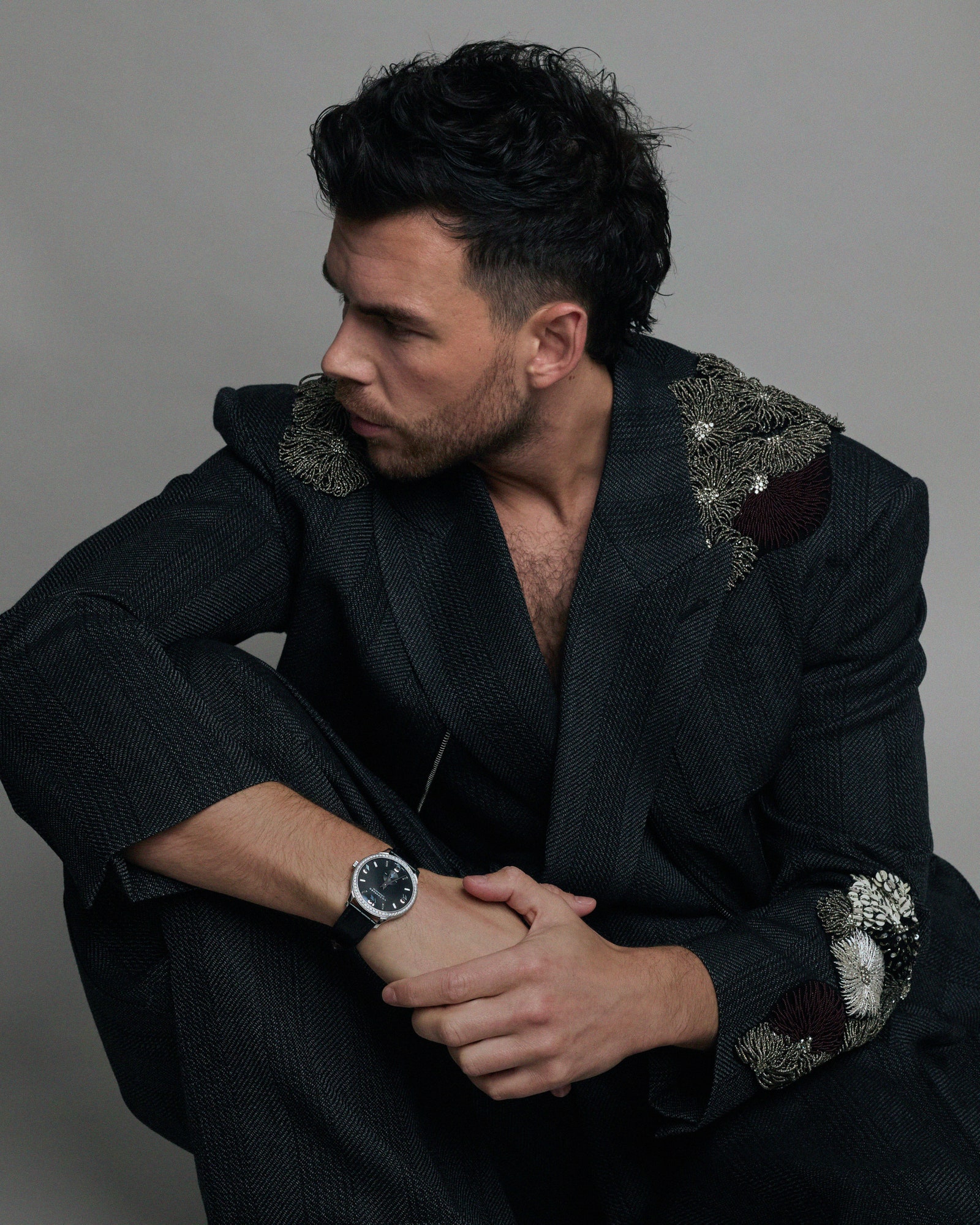 Image may contain Black Hair Hair Person Wristwatch Adult Face Head Photography Portrait Clothing and Formal Wear