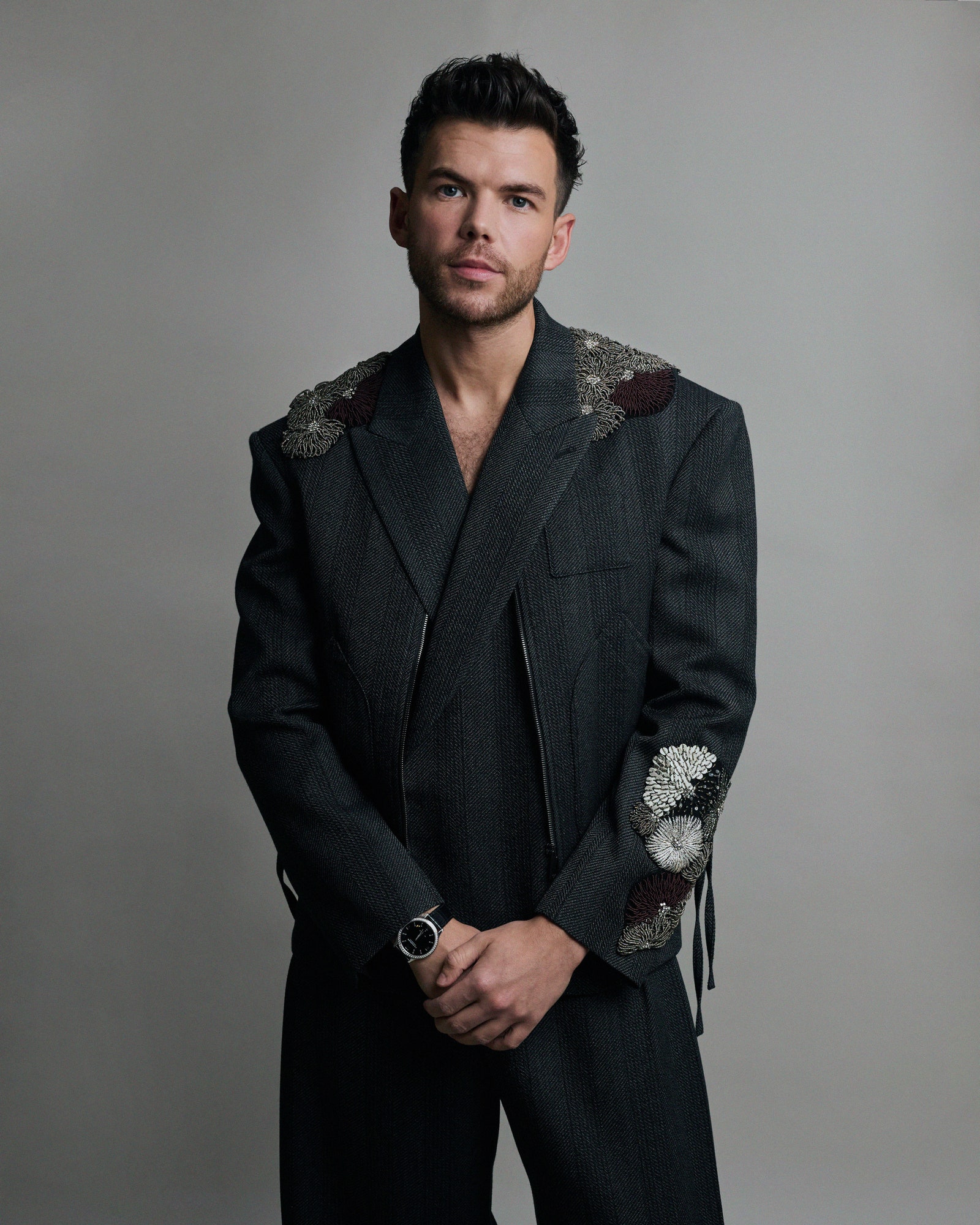 Image may contain Blazer Clothing Coat Formal Wear Jacket Suit Adult Person Tuxedo Wristwatch Head and Face