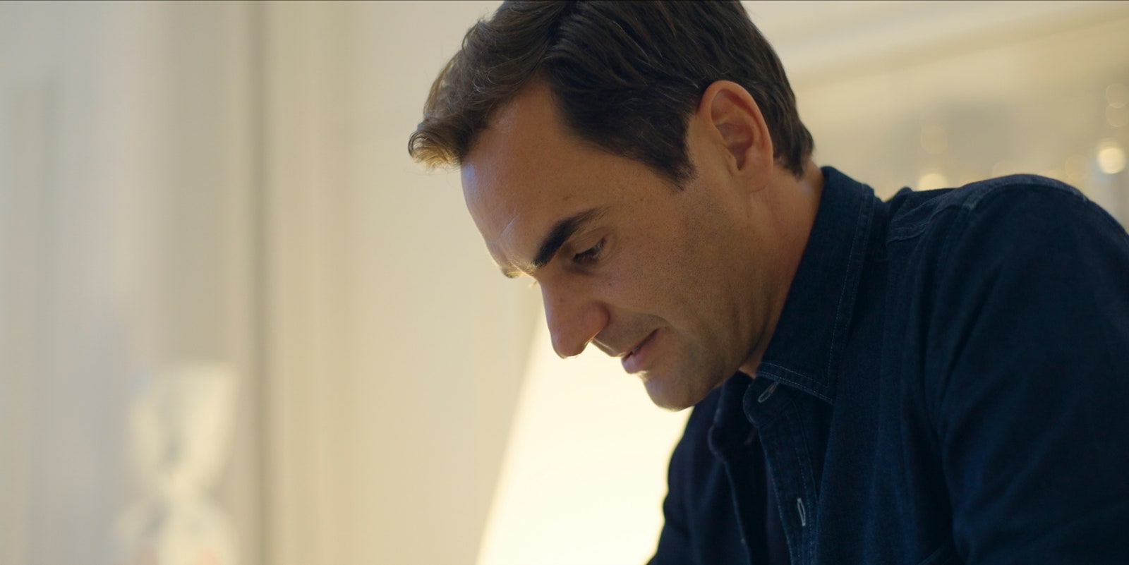Image may contain Roger Federer Head Person Face Photography Portrait Adult Happy and Smile