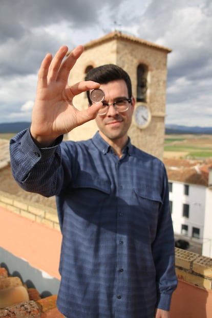 César Sebastián sostiene el ronson, la moneda que le regaló su padre.