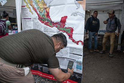Un migrante entra al código QR del mapa de México en el que se indican las casas de asistencia para las personas que viajan hacia el norte. Imagen tomada el 27 de julio de 2024 en la Frontera de Agua Caliente, entre Honduras y Guatemala.