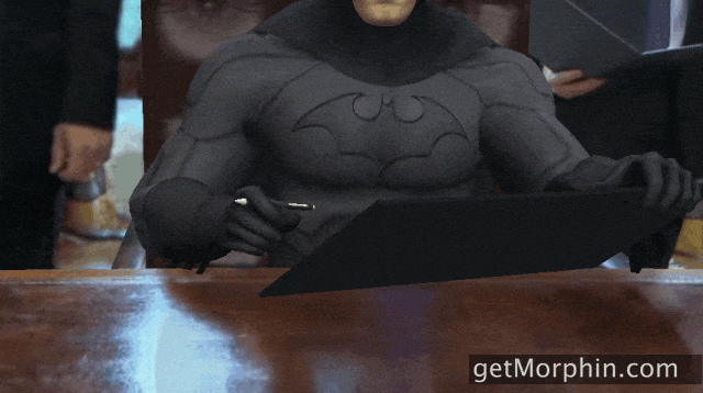 Batman mostrando un cartel donde pregunta si lo amas luego de saber que Batman: Shadows será un juego en primera persona en realidad virtual.- Blog Hola Telcel 