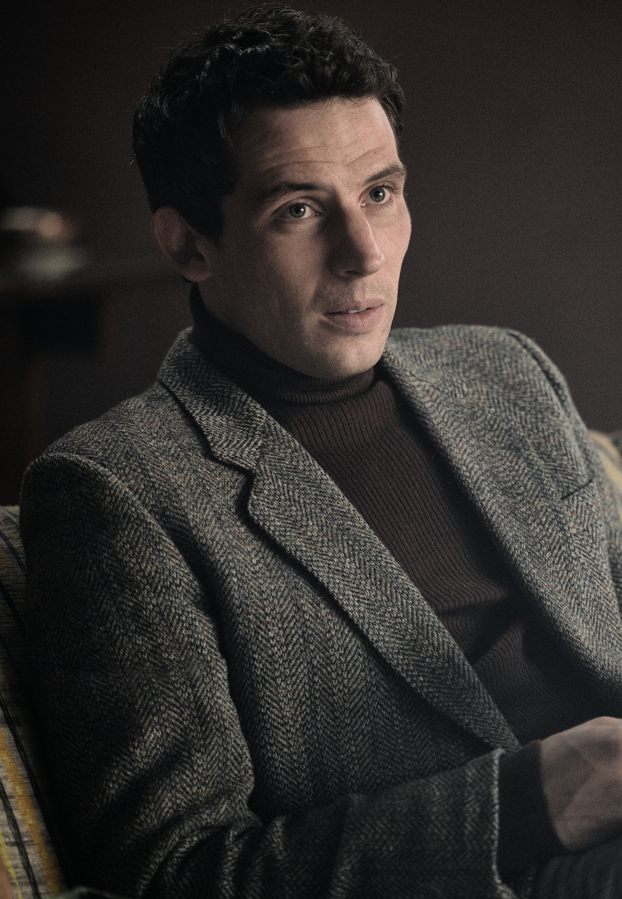 Image may contain Josh O'Connor Clothing Coat Face Head Person Photography Portrait Adult Happy and Smile