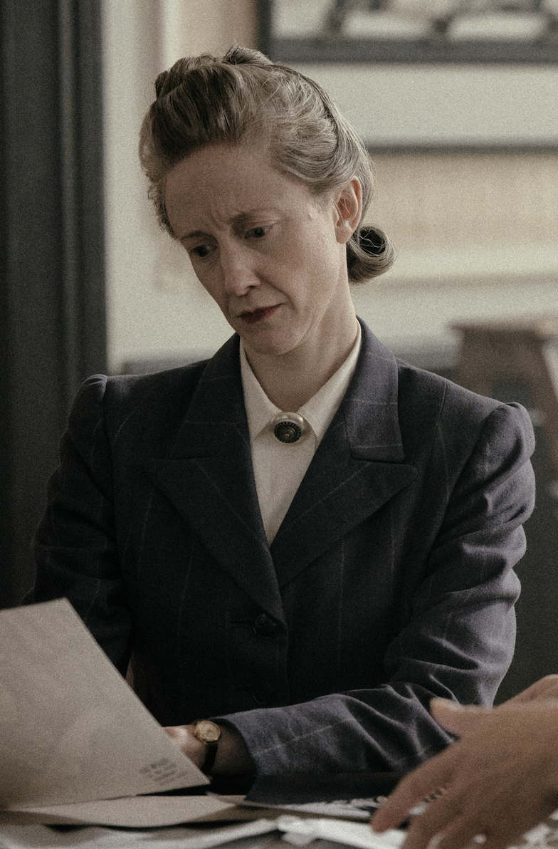 Image may contain Andrea Riseborough Adult Person Face Head Photography Portrait Formal Wear Clothing and Suit