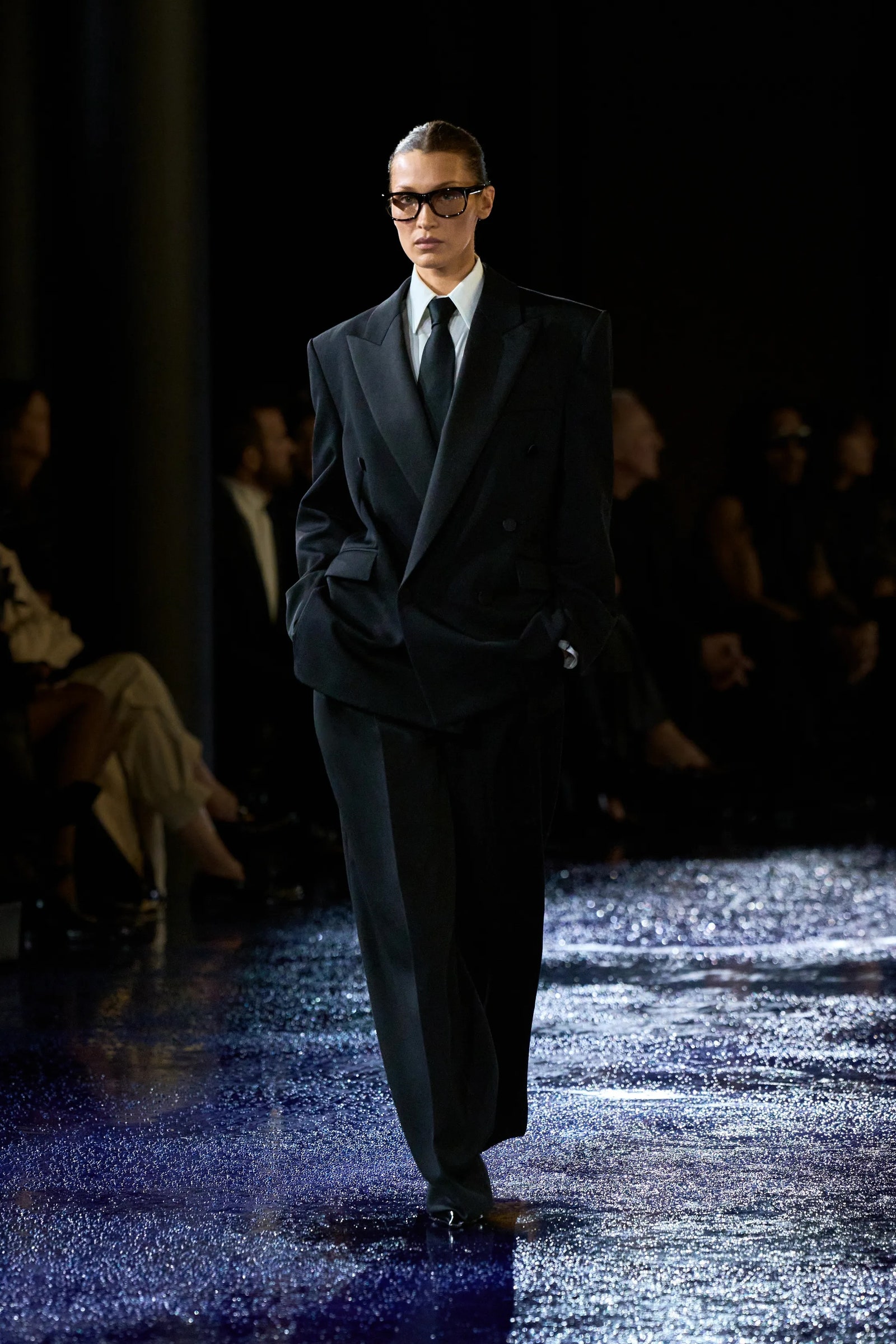 Image may contain Bella Hadid Fashion Clothing Formal Wear Suit Coat Adult Person Accessories Glasses and Tie
