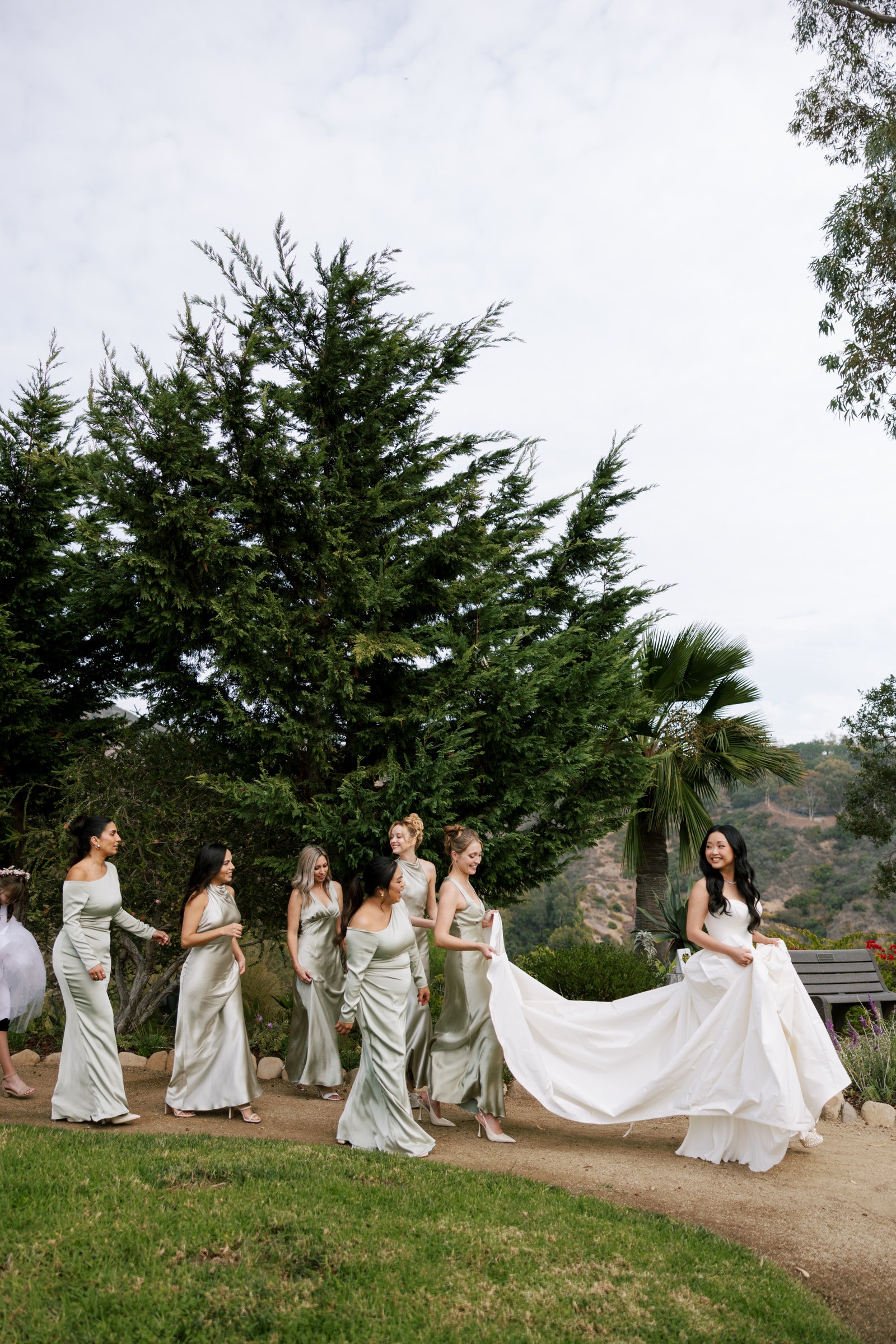 Image may contain Lana Condor Eliana Printes Clothing Dress Fashion Formal Wear Gown Wedding Wedding Gown and Grass