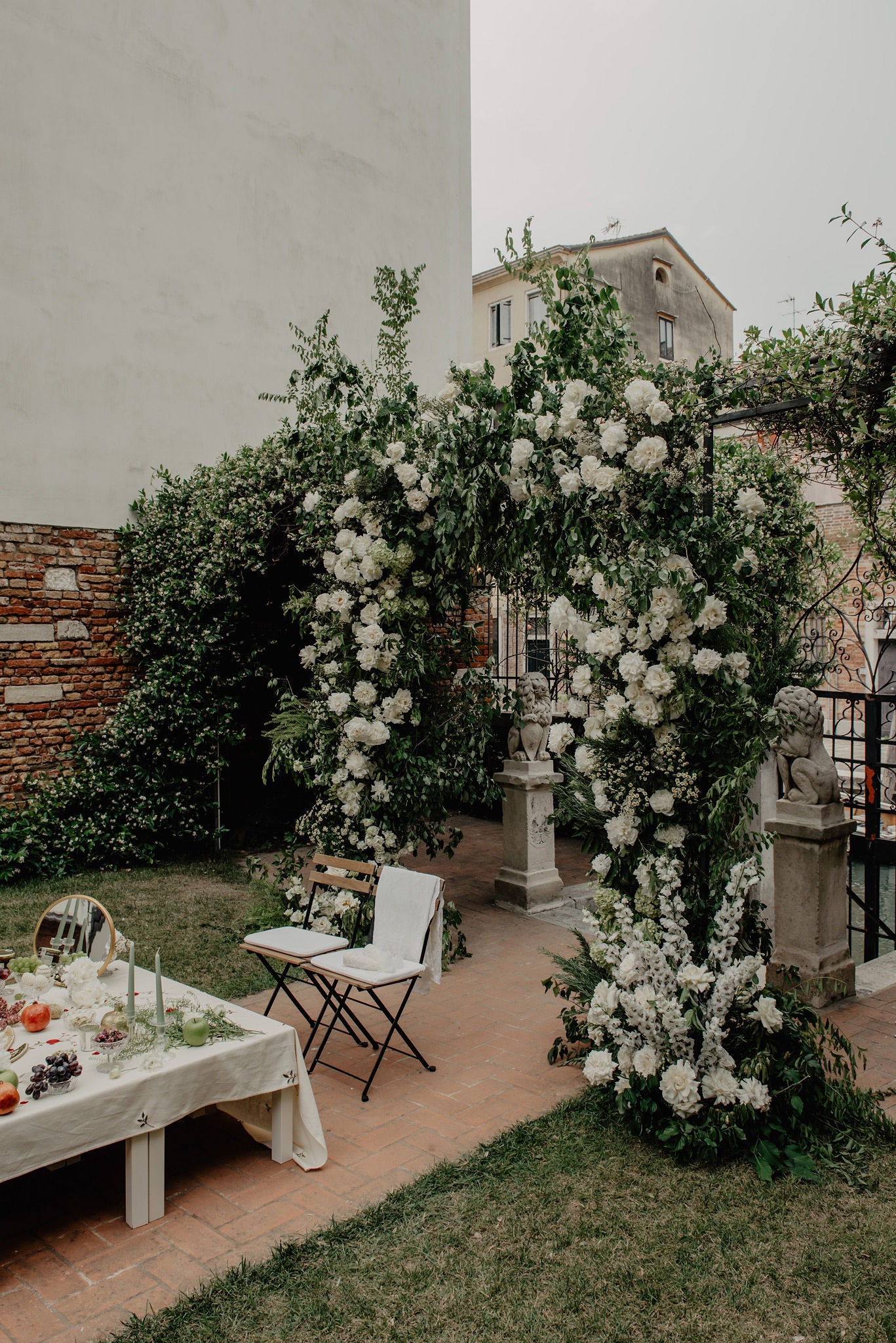 Image may contain Chair Furniture Desk Table Animal Lion Mammal Wildlife Flower Plant Candle and Cup