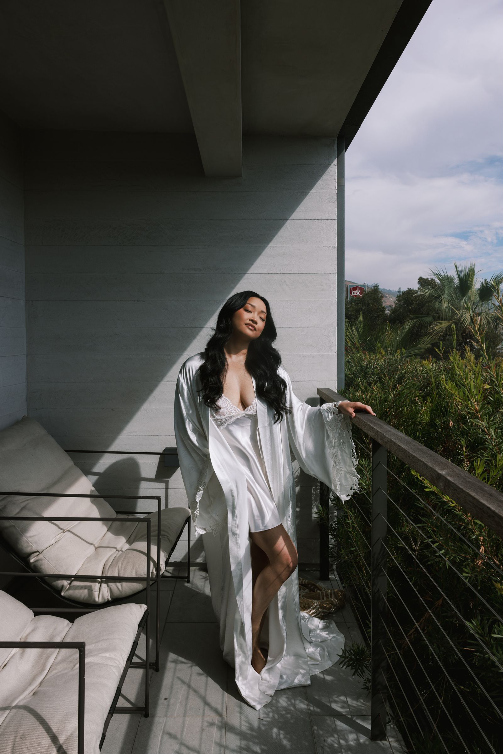 Image may contain Lana Condor Adult Person Clothing Dress Architecture Balcony Building Fashion and Beachwear