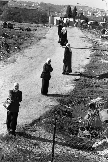 Un grupo de mujeres camina hacia un puesto de control israelí cerca de Belén, en Cisjordania, en 2002, durante la segunda Intifada palestina. Imagen perteneciente a la Joss Dray Collection.