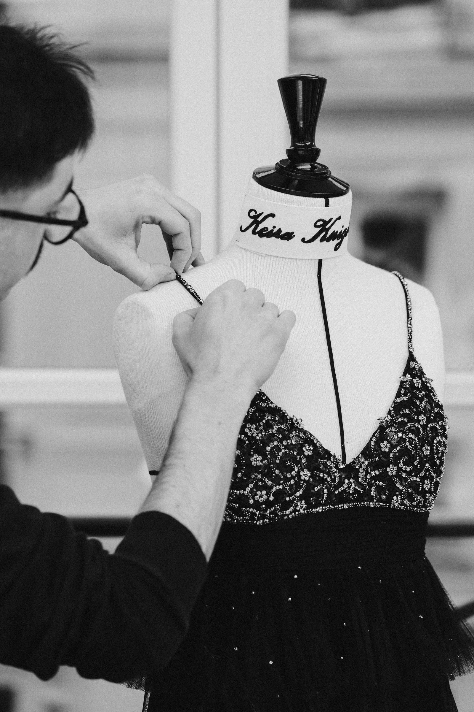 Image may contain Body Part Finger Hand Person Adult Clothing Dress Formal Wear Face and Head