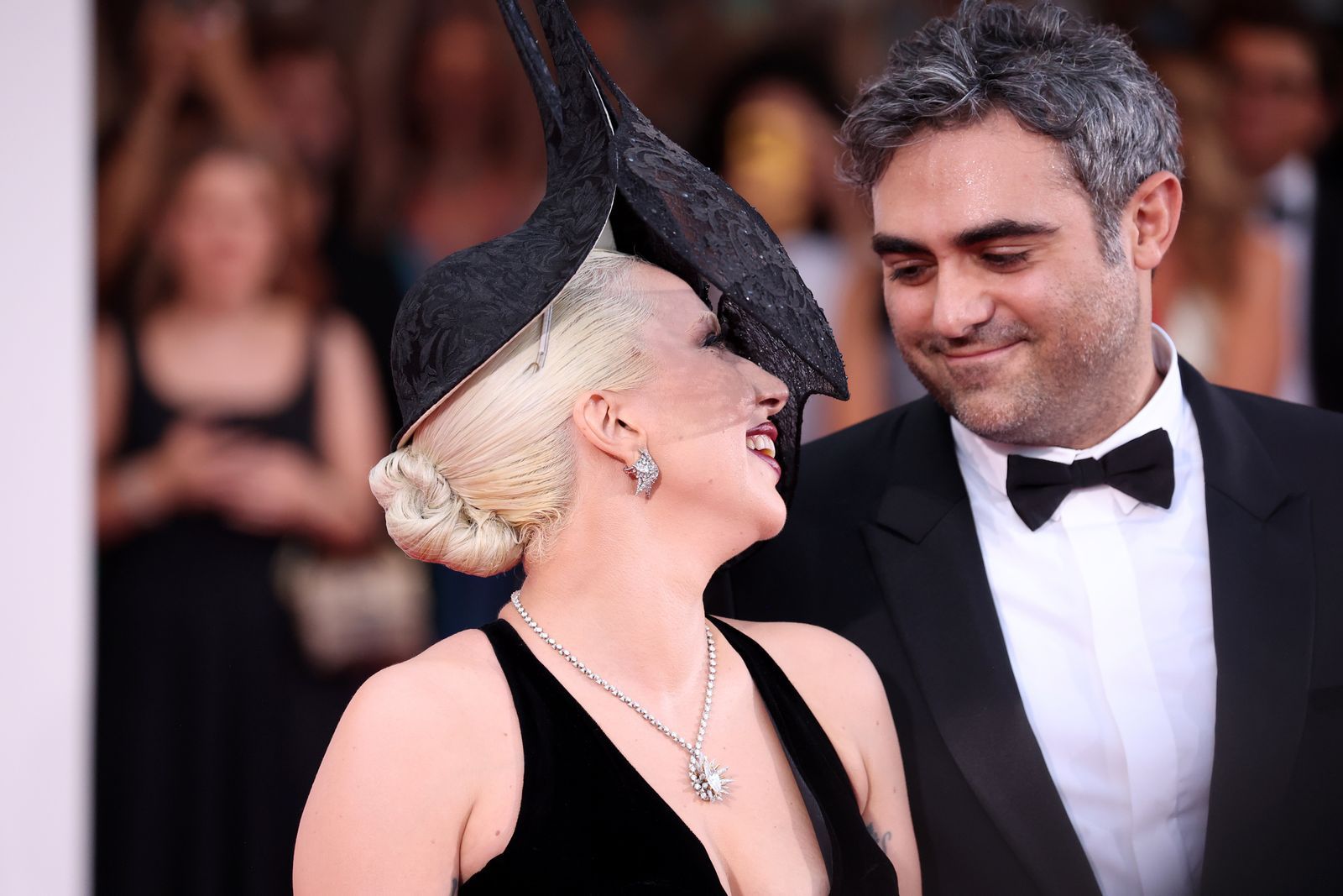 Image may contain Lady Gaga Person Accessories Formal Wear Tie Jewelry Necklace Adult Clothing Suit Head and Face