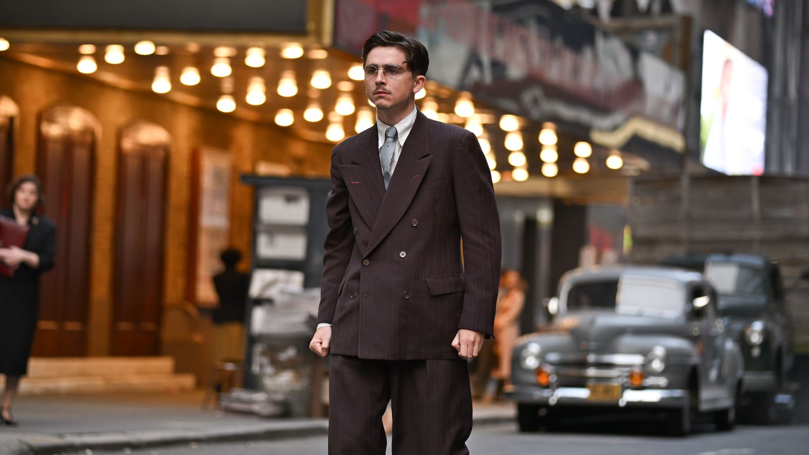 Image may contain Timothe Chalamet Clothing Formal Wear Suit Coat Blazer Jacket Person Adult and Walking