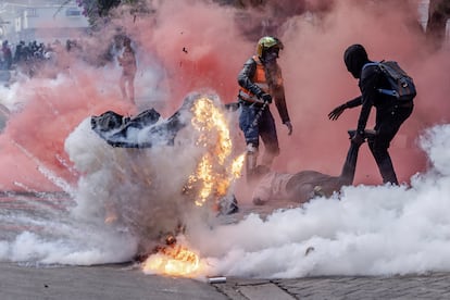 Un bote de gas lacrimógeno explota mientras los manifestantes intentan ayudar a las personas heridas durante las protestas ante el Parlamento de Kenia, el 25 de junio de 2024.