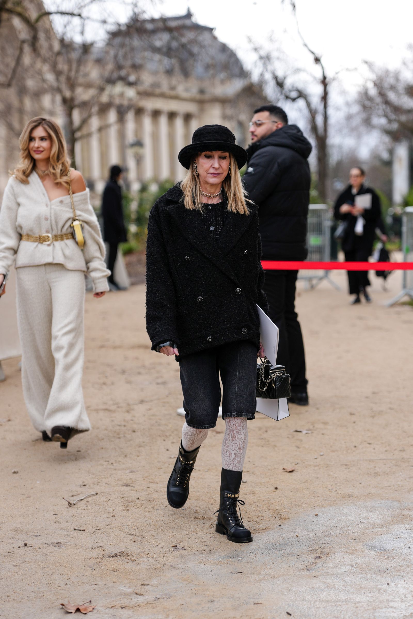 Image may contain Clothing Coat Footwear Shoe Person Hat Accessories Belt Adult Bag Handbag and High Heel