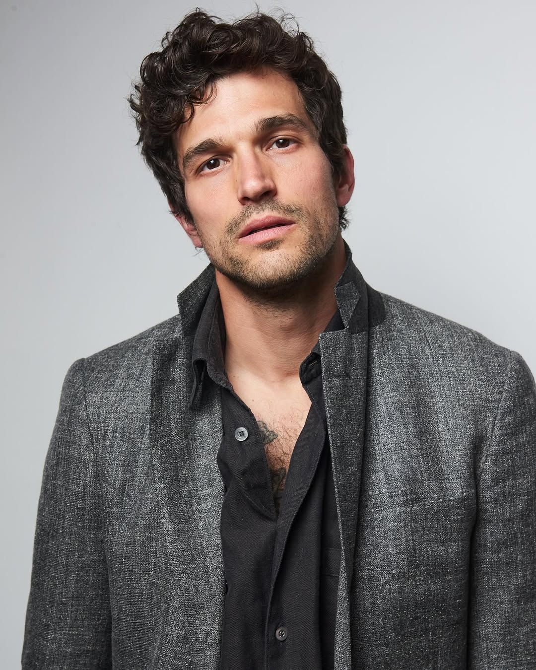 Image may contain Head Person Face Photography Portrait Body Part Neck Clothing Coat Adult Blazer and Jacket