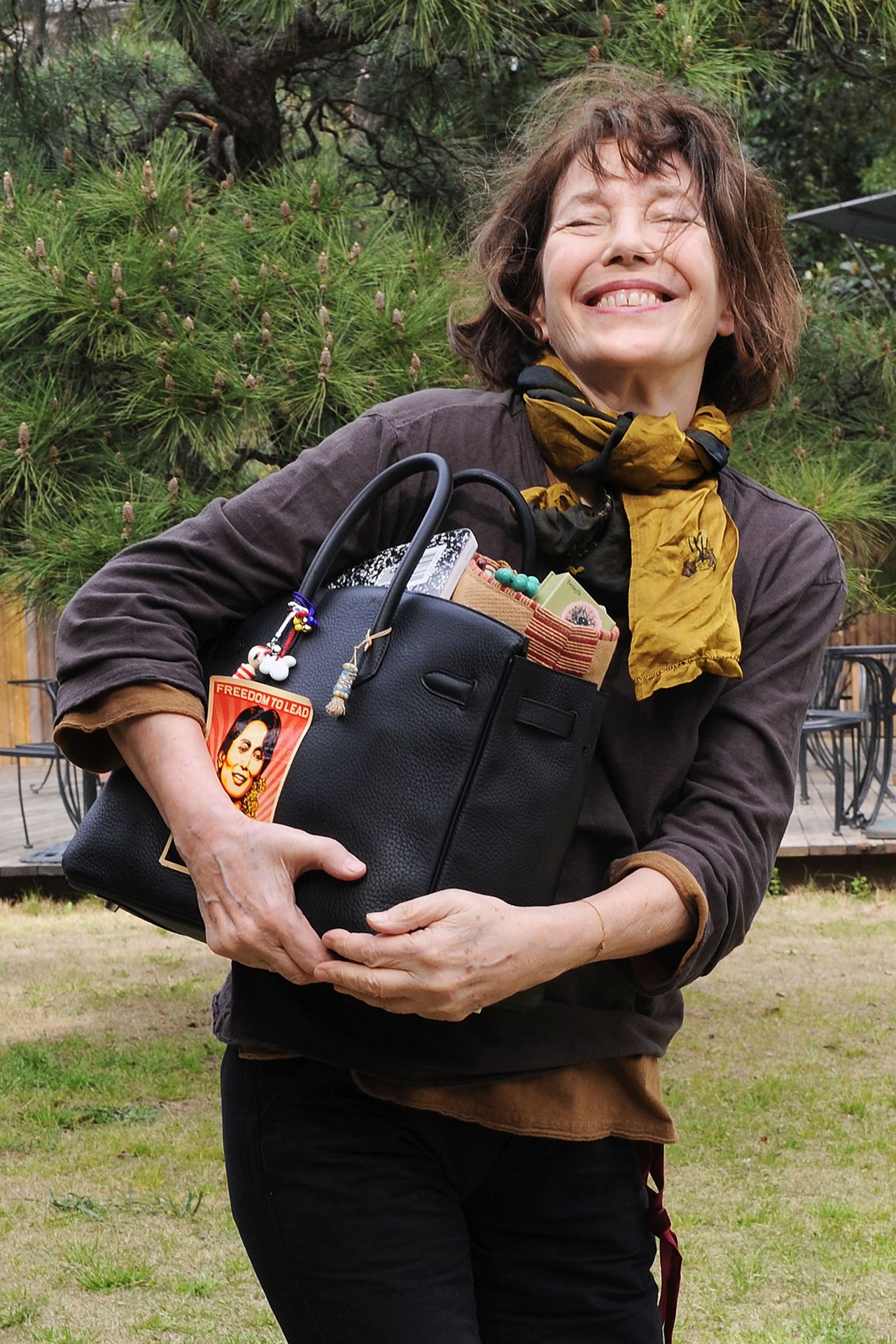 Image may contain Jane Birkin Aung San Suu Kyi Face Head Person Photography Portrait Accessories Bag and Handbag
