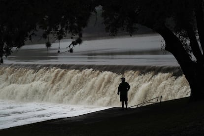 Un hombre observa el paso del río Guadalupe por encima de una presa, donde el río alcanzó 10,5 metros en su cresta el 4 de julio.