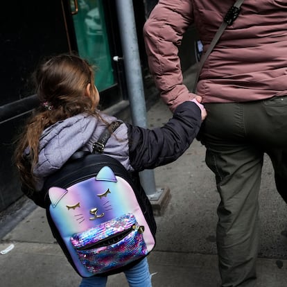 An Ecuadorian migrant holds the hand of her 5-year-old daughter as they leave the The Roosevelt Hotel where she came to enquire about a work permit after New York City Mayor Eric Adams announced the forthcoming closure of the Asylum Seeker Arrival Center and Humanitarian Emergency Response and Relief Center located at The Roosevelt Hotel, in midtown Manhattan in New York City, U.S., February 24, 2025. REUTERS/Adam Gray
