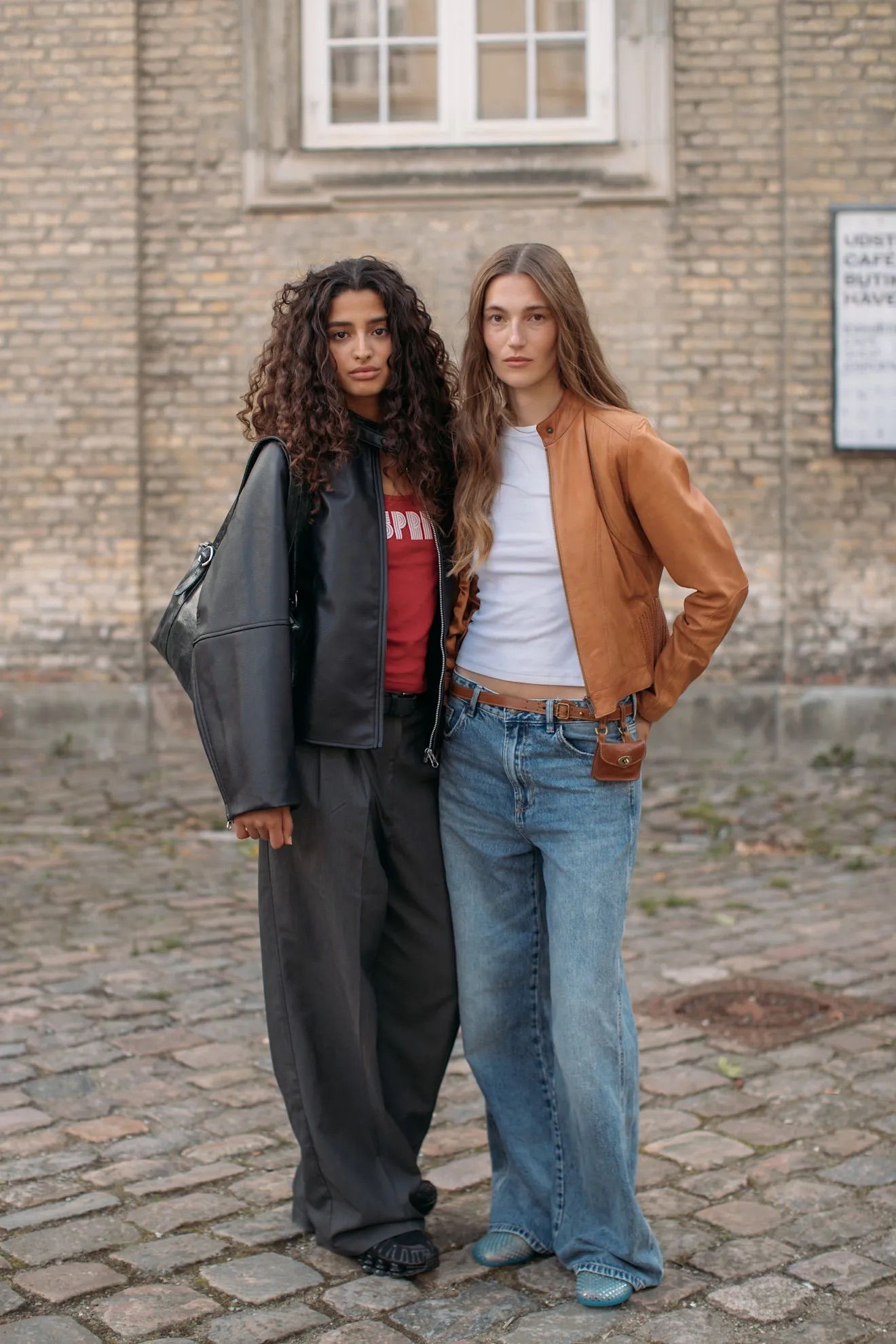 Image may contain Clothing Pants Adult Person Hair Brown Hair Curly Hair Footwear Shoe Accessories Belt and Bag