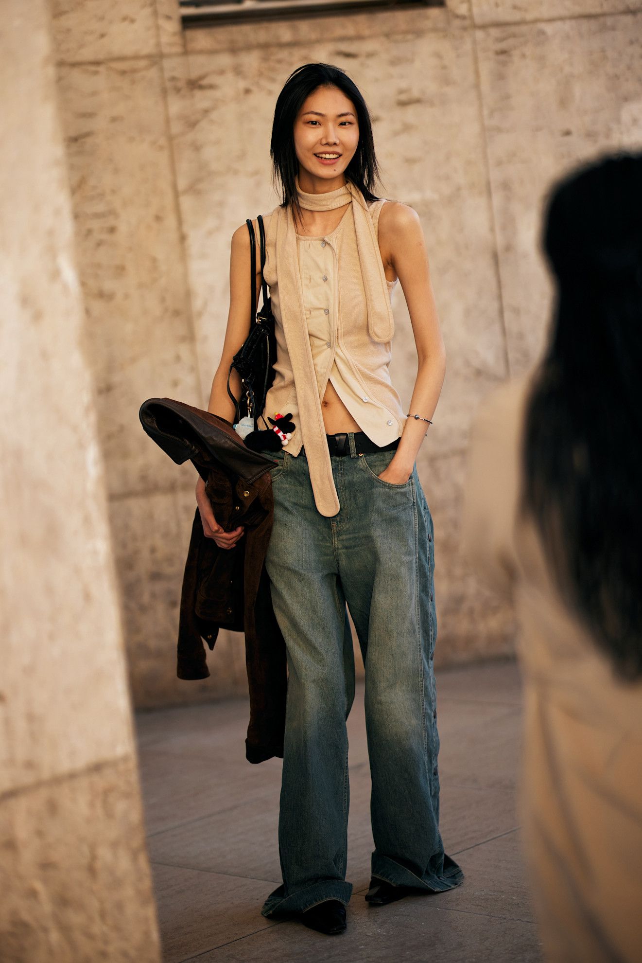 Image may contain Clothing Pants Jeans Adult Person Accessories Bag Handbag Glove Belt Bracelet and Jewelry