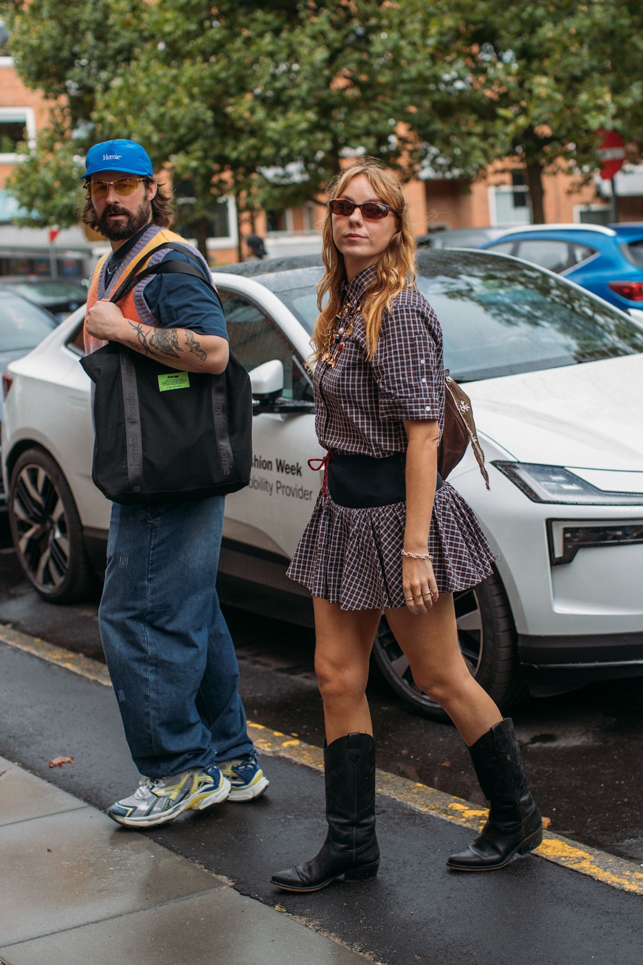 Image may contain Clothing Footwear Shoe Hat Accessories Glasses Bag Handbag Person Teen Adult and Car