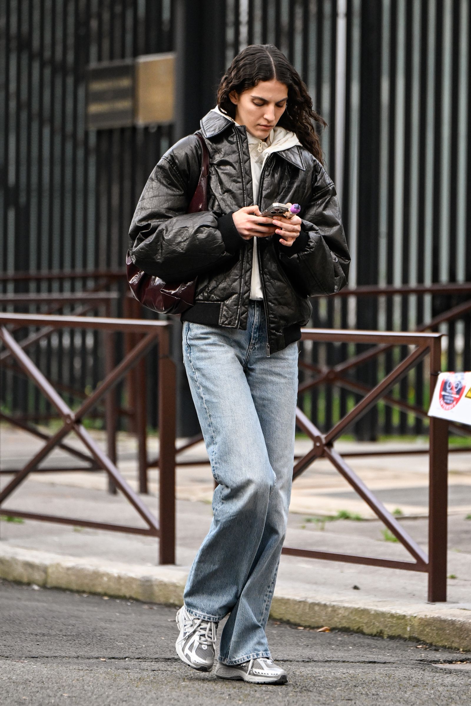 Image may contain Clothing Pants Jeans Person Coat Jacket Accessories Bag Handbag Pedestrian Footwear and Shoe