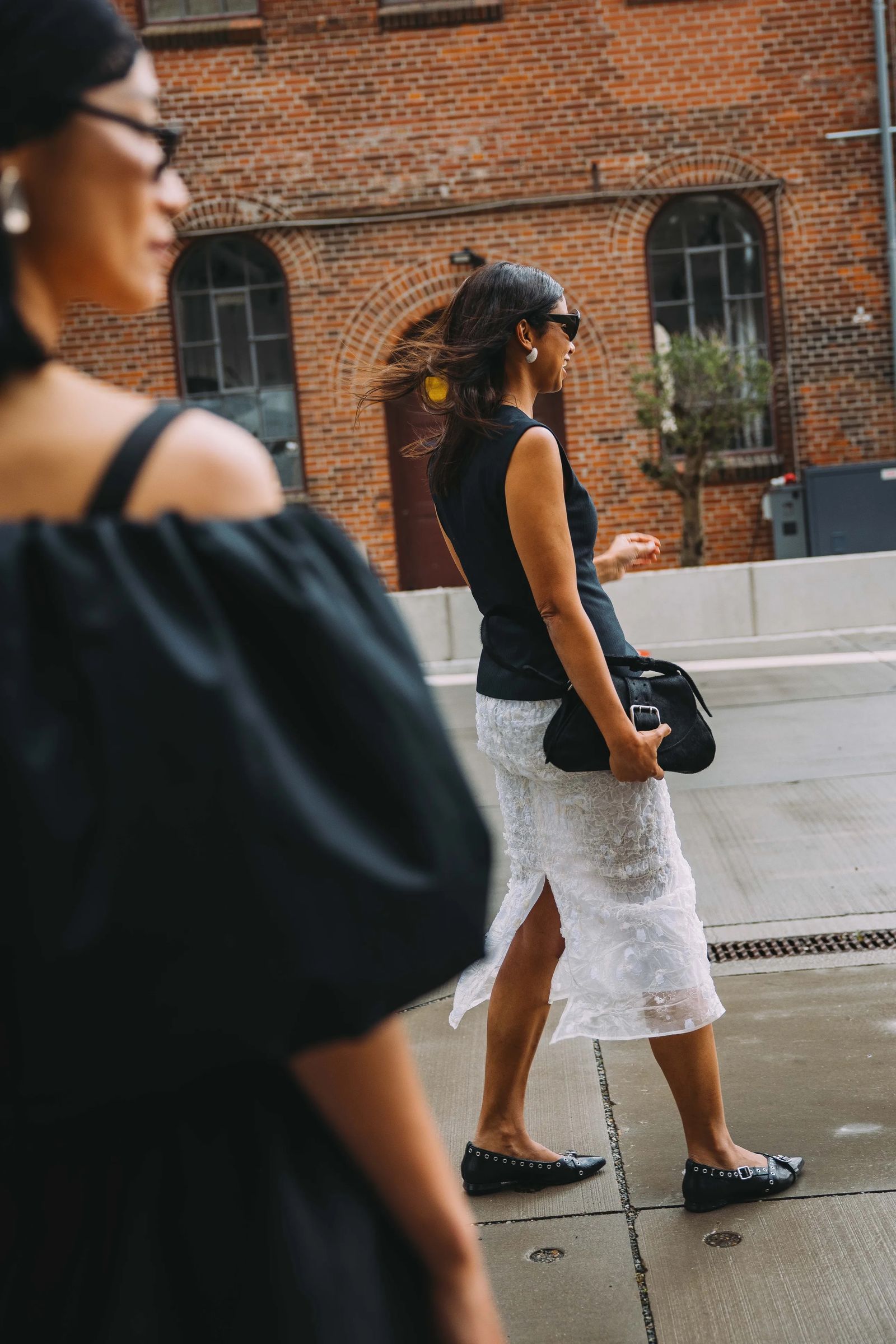 Image may contain Accessories Bag Handbag Adult Person Clothing Skirt Footwear Shoe Glasses and Pedestrian