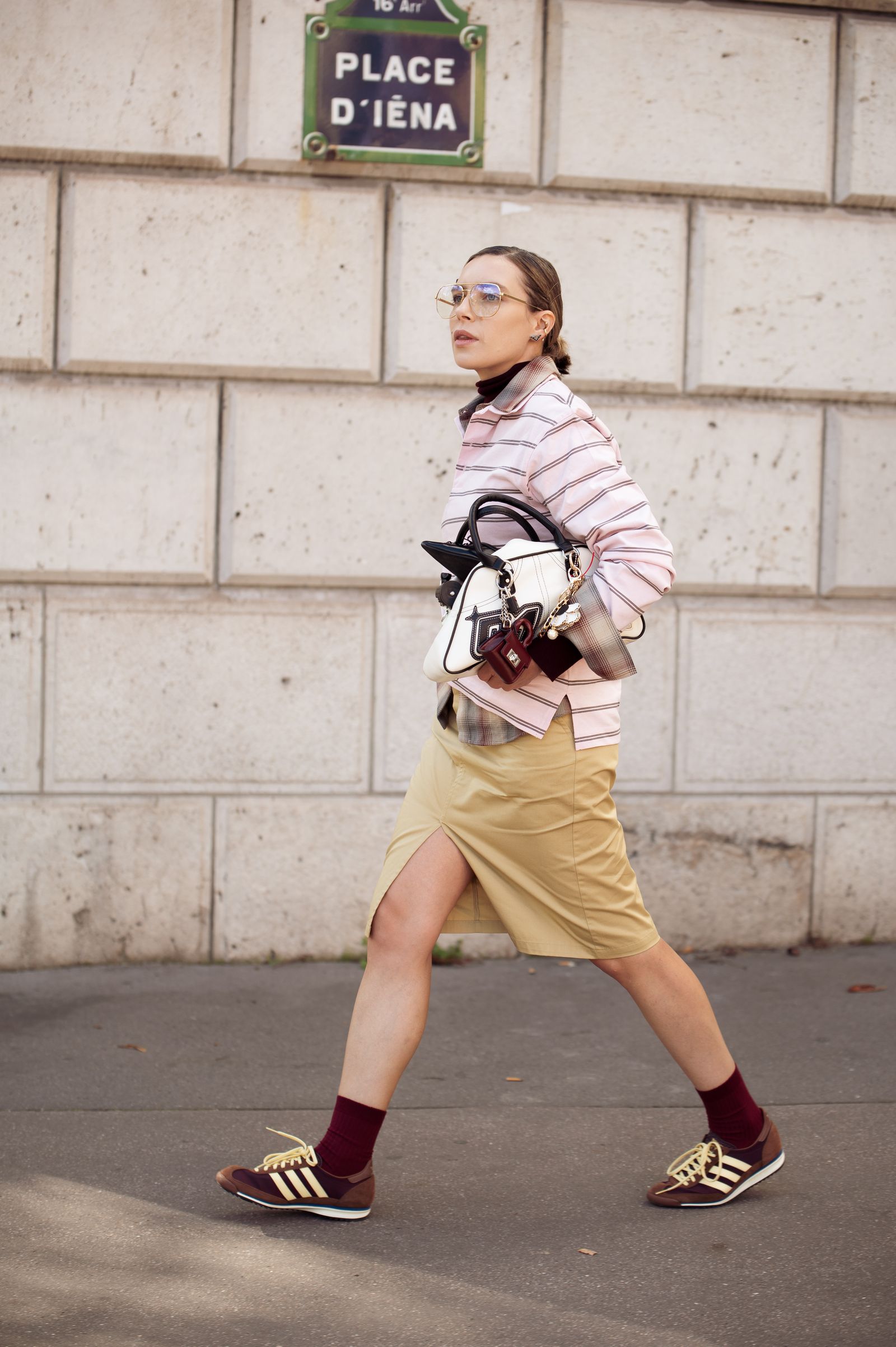 Image may contain Clothing Shorts Pedestrian Person Footwear Shoe Accessories Bag Handbag Glasses and Sneaker