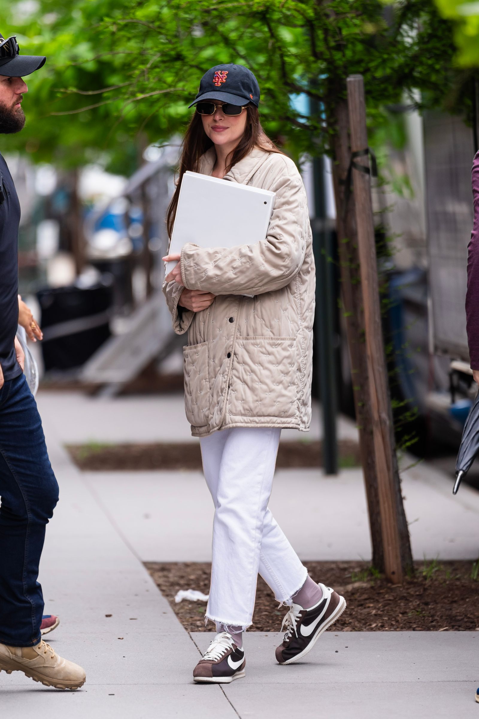 Image may contain Dakota Johnson Pedestrian Person Clothing Footwear Shoe Hat Adult Accessories Glasses and Coat