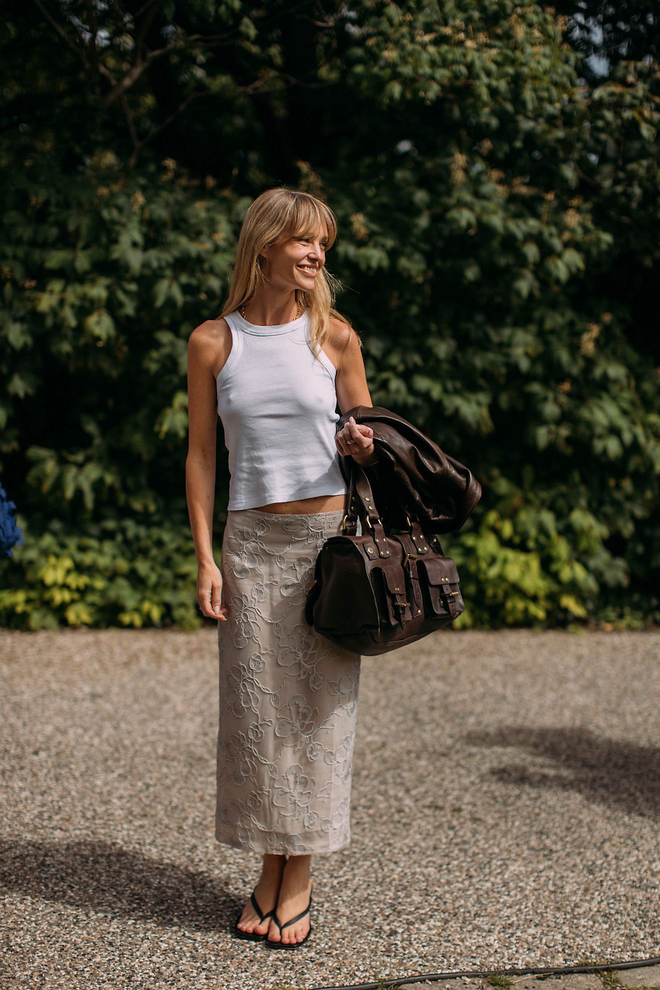 Image may contain Accessories Bag Handbag Clothing Skirt Adult Person Pants Footwear Shoe Jewelry and Necklace