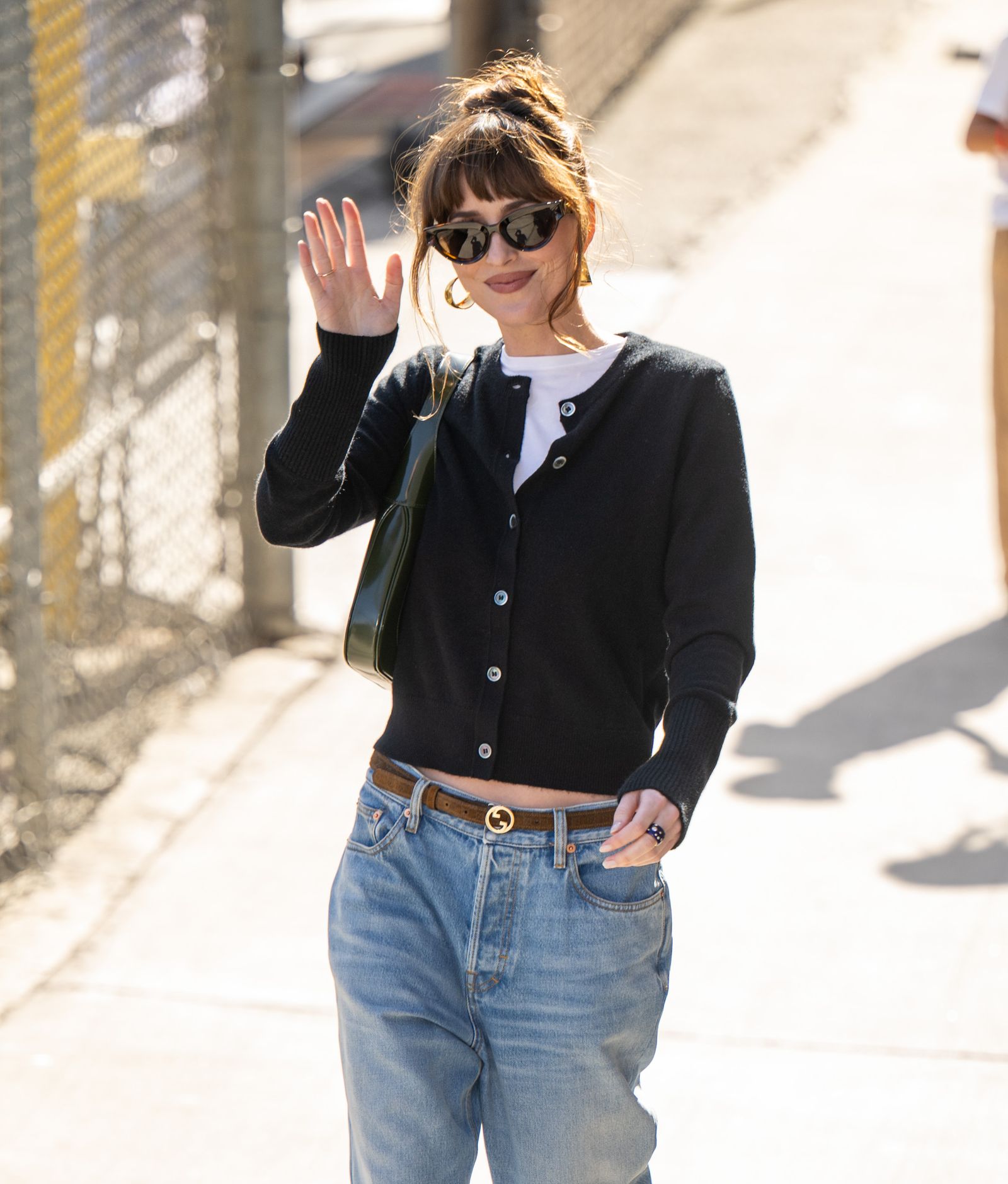Image may contain Dakota Johnson Blazer Clothing Coat Jacket Pants Jeans Accessories Belt Glasses Person and Bag