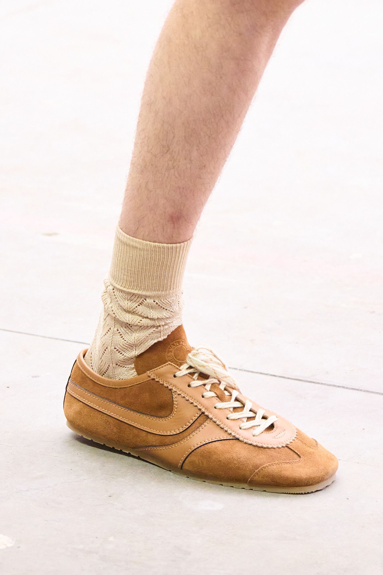 Image may contain Clothing Footwear Shoe Sneaker Suede Hosiery Sock and Person