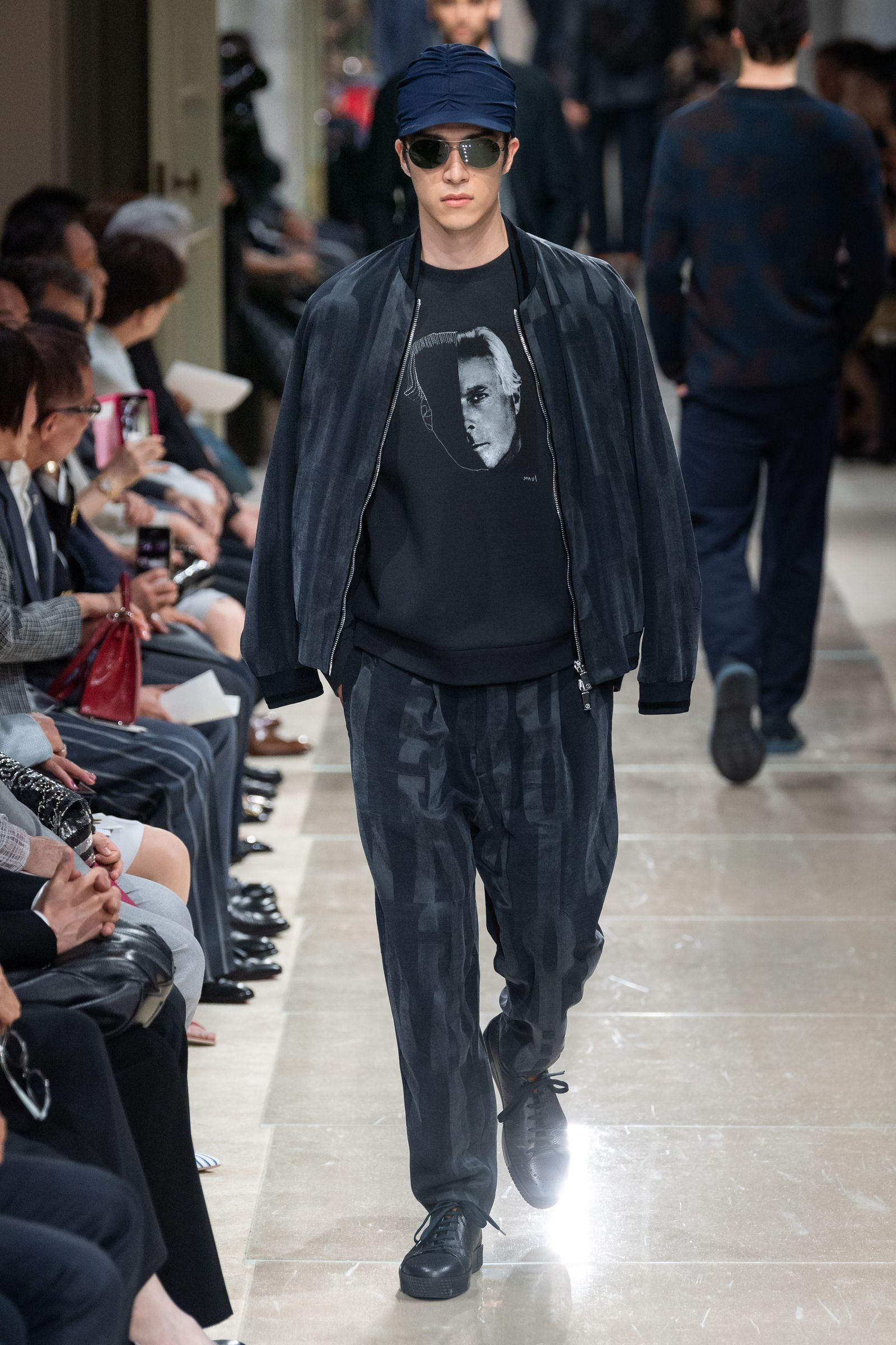 This image may contain Human Person Sunglasses Accessories Accessory Footwear Clothing Apparel Shoe Coat and Jacket