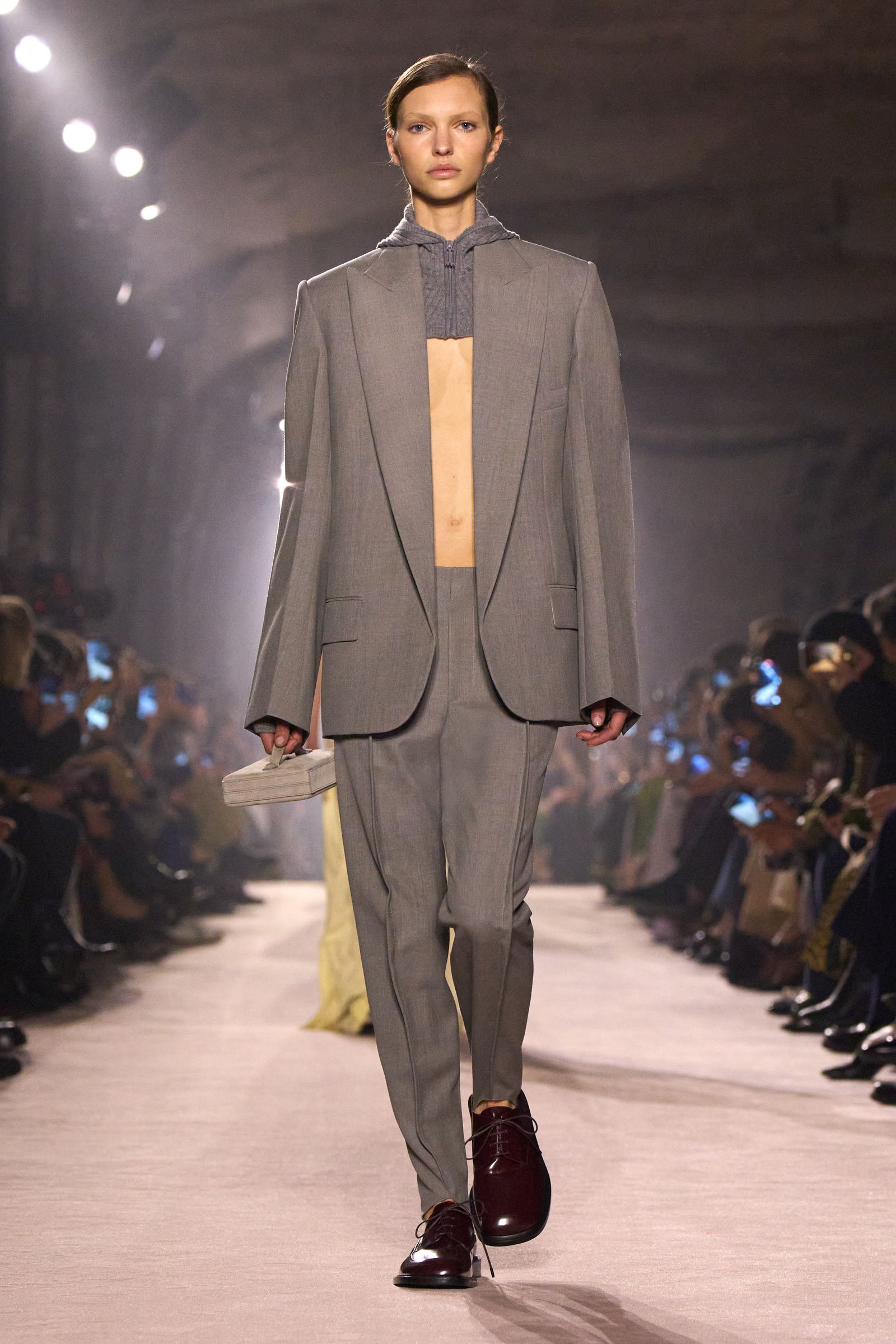 Image may contain Fashion Clothing Formal Wear Suit Adult Person Coat Runway Footwear and Shoe