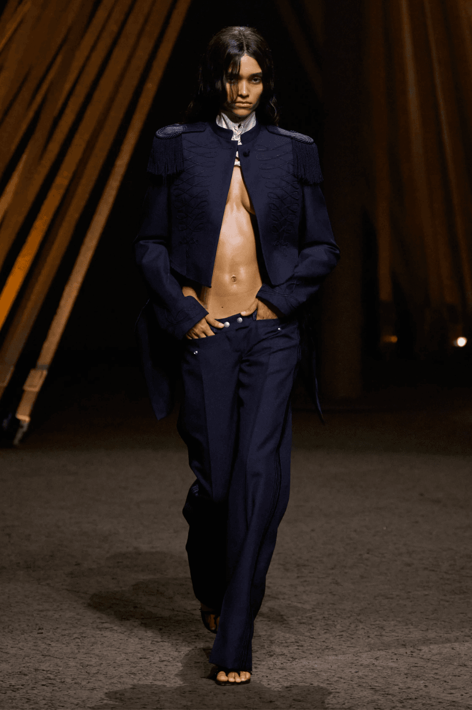 Image may contain Fashion Clothing Formal Wear Suit Coat Jacket Adult Person Blazer Face Head and Pants