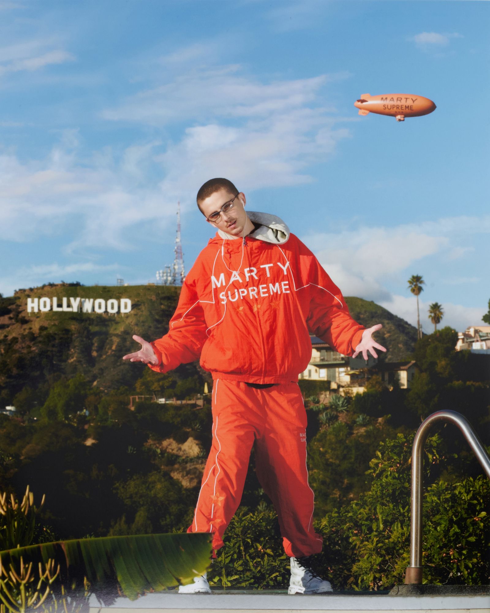 Image may contain Timothe Chalamet Photography Clothing Coat Face Head Person Portrait Teen and Aircraft