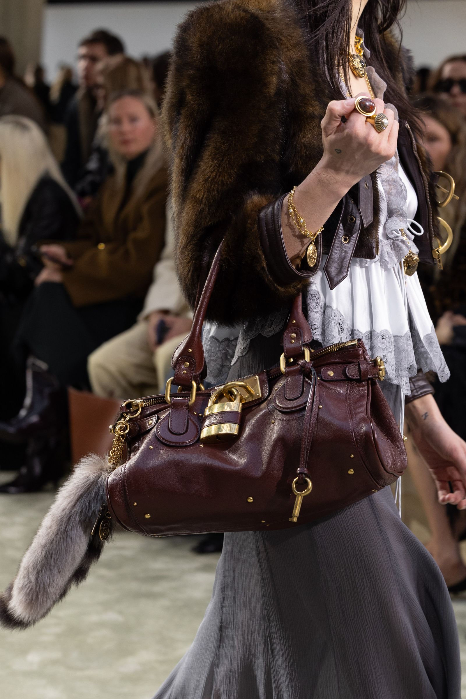 Image may contain Accessories Bag Handbag Purse Adult Person Jewelry Ring Glasses Clothing and Coat