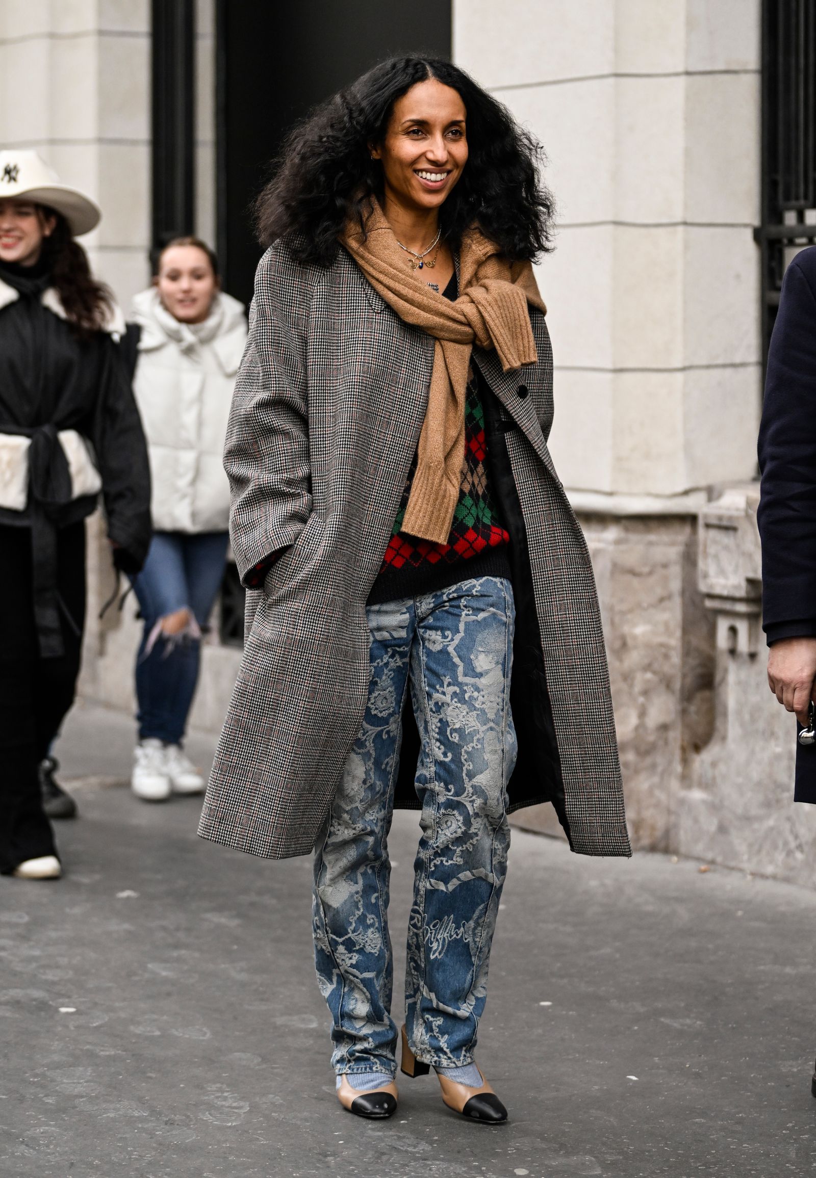 Image may contain Clothing Coat Pants Adult Person Scarf and Jeans