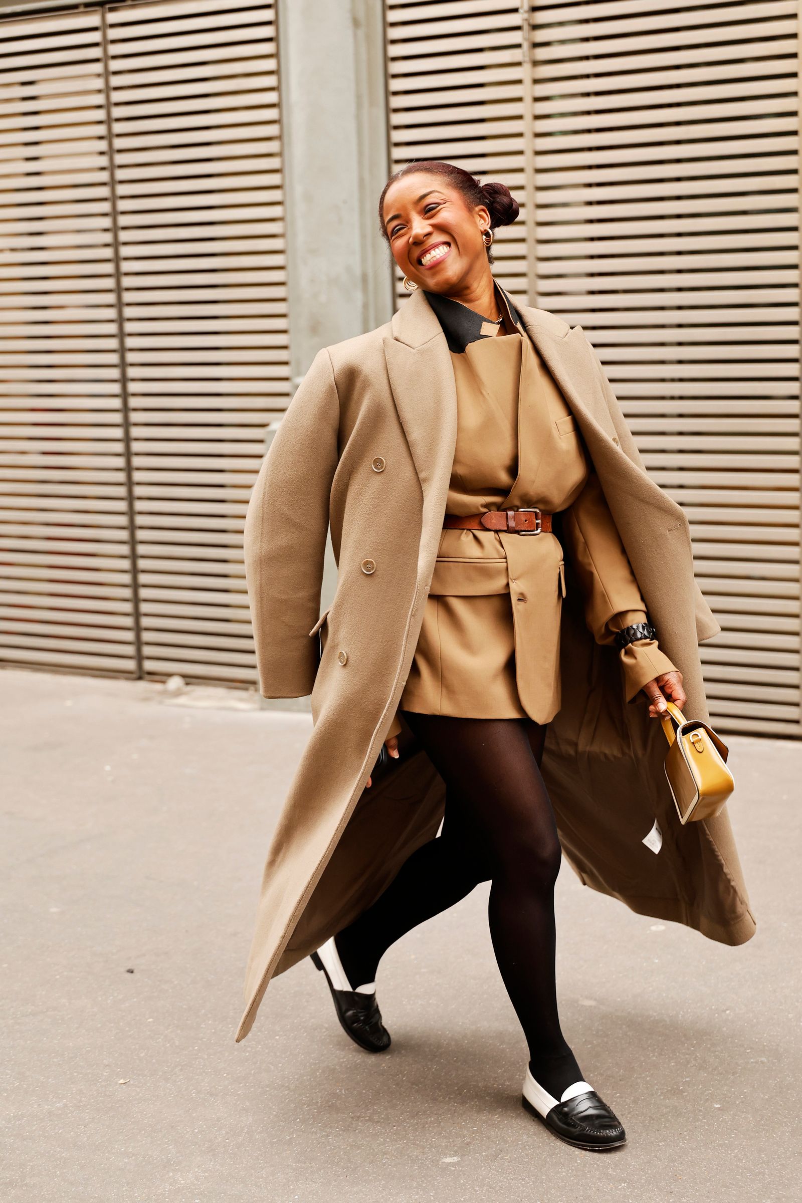 PARIS FRANCE  JANUARY 25 Angela Baidoo wears tan blazer with a brown leather belt on the waist black tights black and...