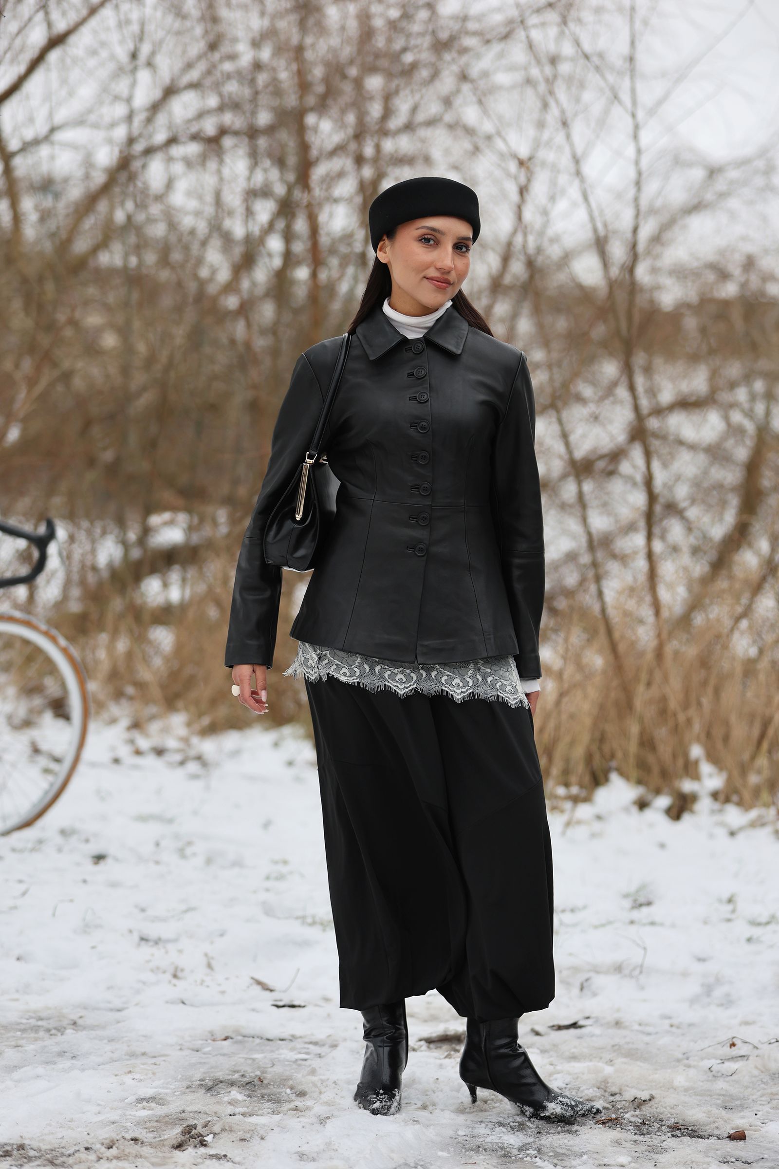 Image may contain Clothing Coat Person Standing Adult Bicycle Transportation and Vehicle