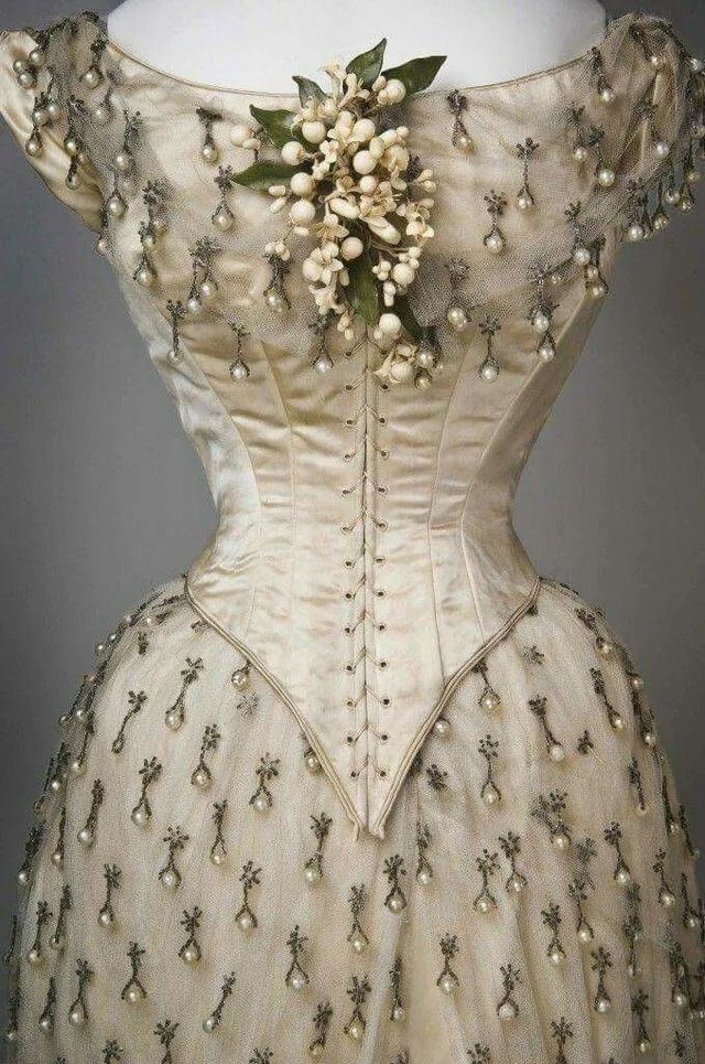 Image may contain Adult Person Wedding Clothing Corset and Dress