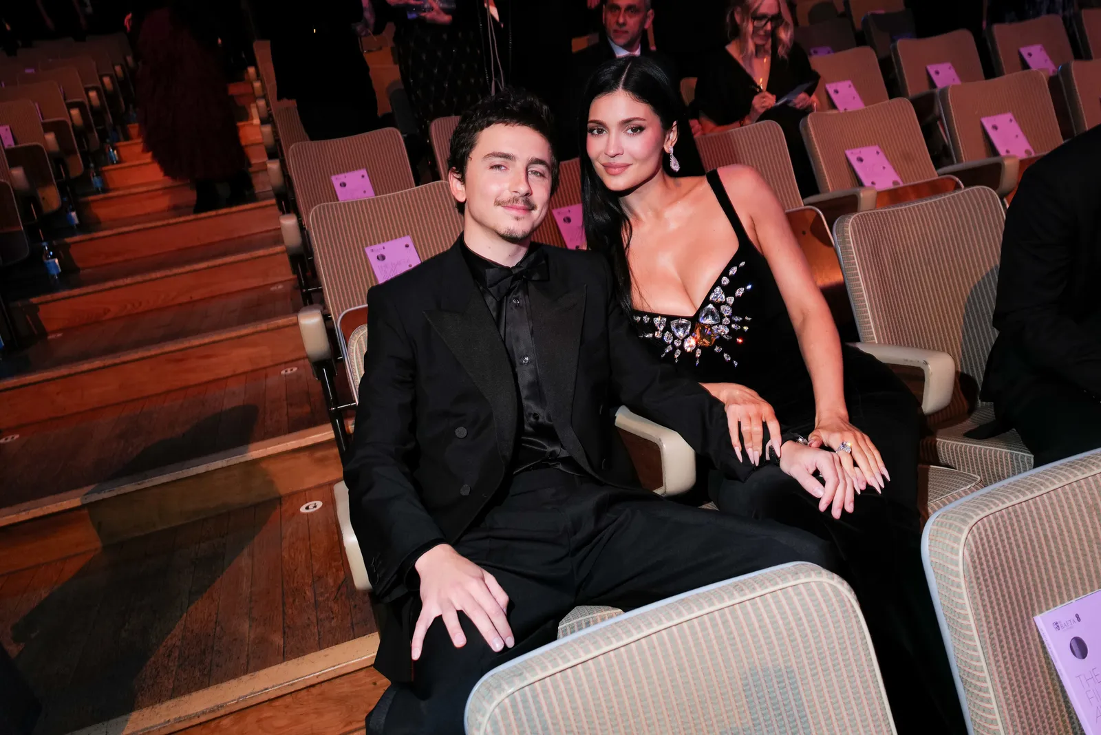 Image may contain Timothe Chalamet Kylie Jenner Adult Person Photobombing Fashion Clothing Formal Wear and Suit