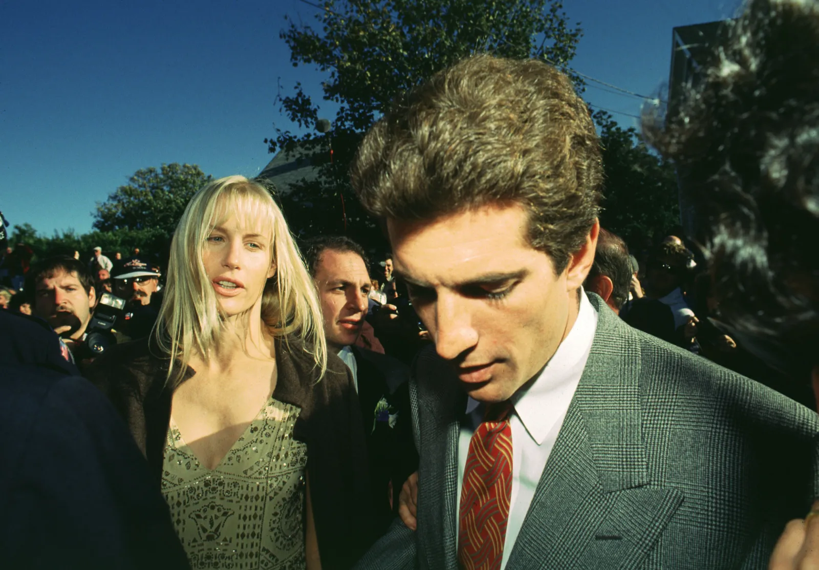 Image may contain John F. Kennedy Jr. Daryl Hannah Akiva Goldsman Clothing Formal Wear Suit Accessories Tie and Face