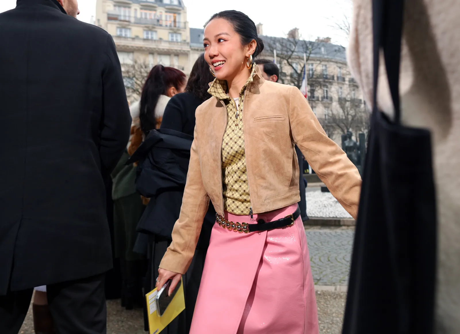 Image may contain Face Happy Head Person Smile Adult Accessories Belt Bag Handbag Formal Wear and Book