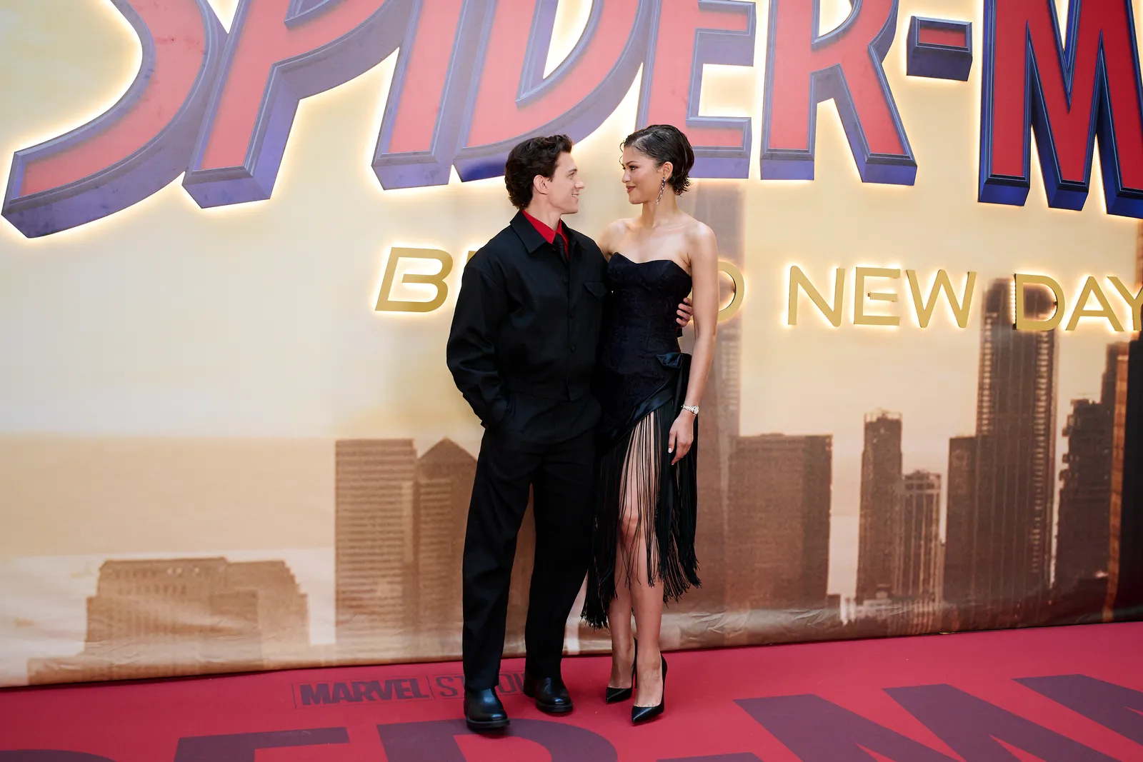 Image may contain Tom Holland Zendaya Fashion Adult Person Clothing and Coat