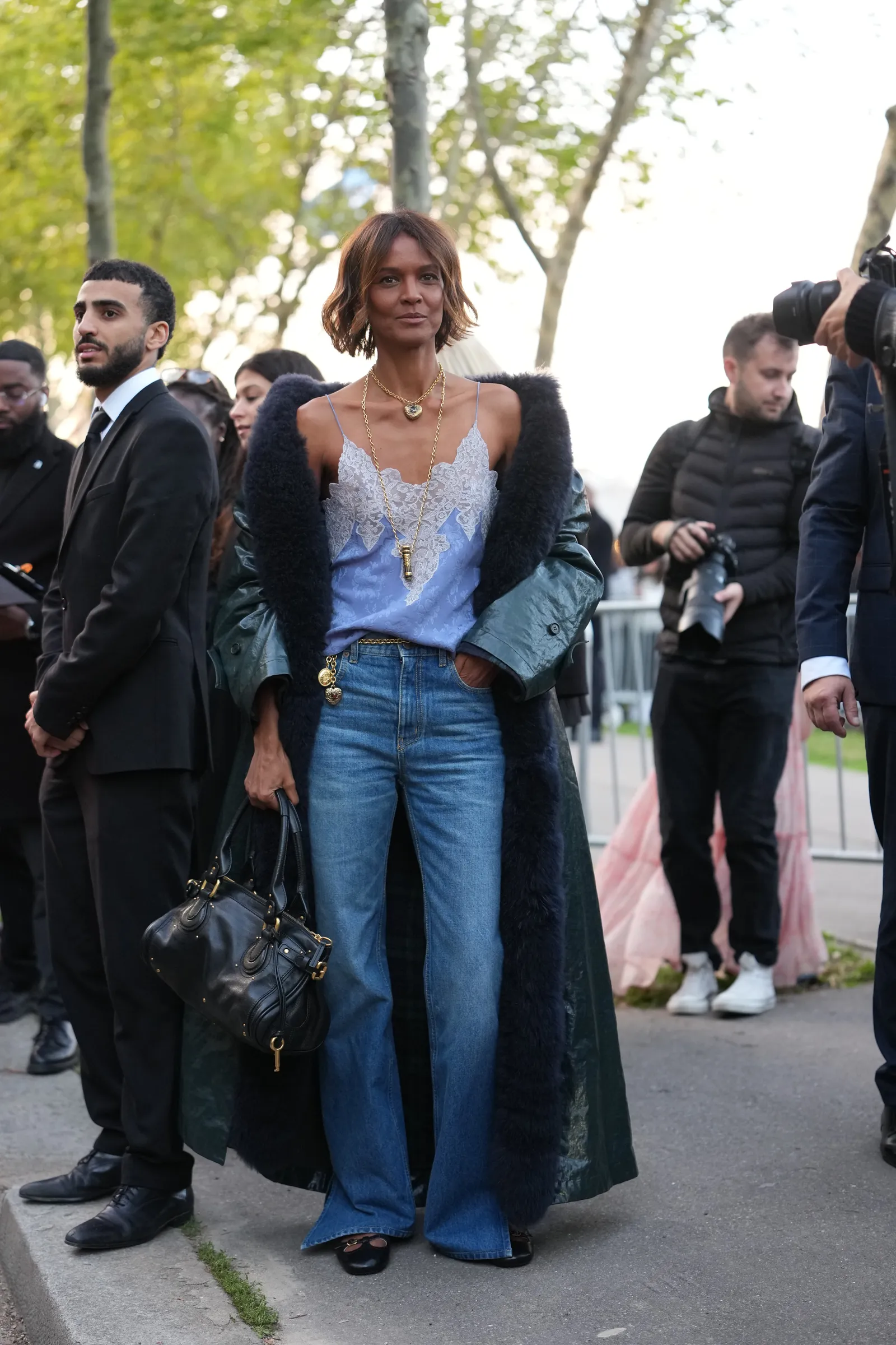 Image may contain Liya Kebede Clothing Pants Jeans Person Accessories Bag Handbag Adult Footwear Shoe and Jewelry