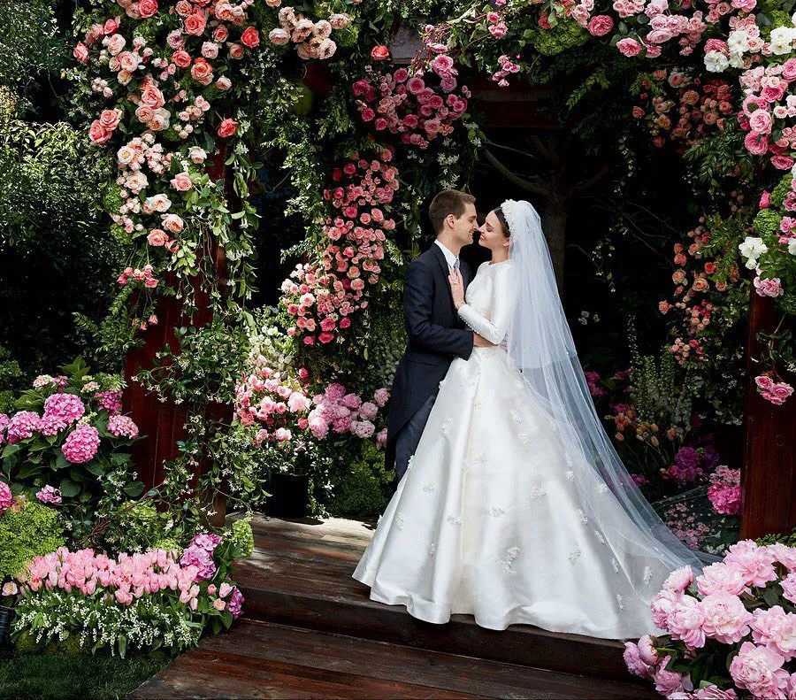 Image may contain Clothing Apparel Human Person Plant Wedding Fashion Wedding Gown Gown Robe Flower and Blossom